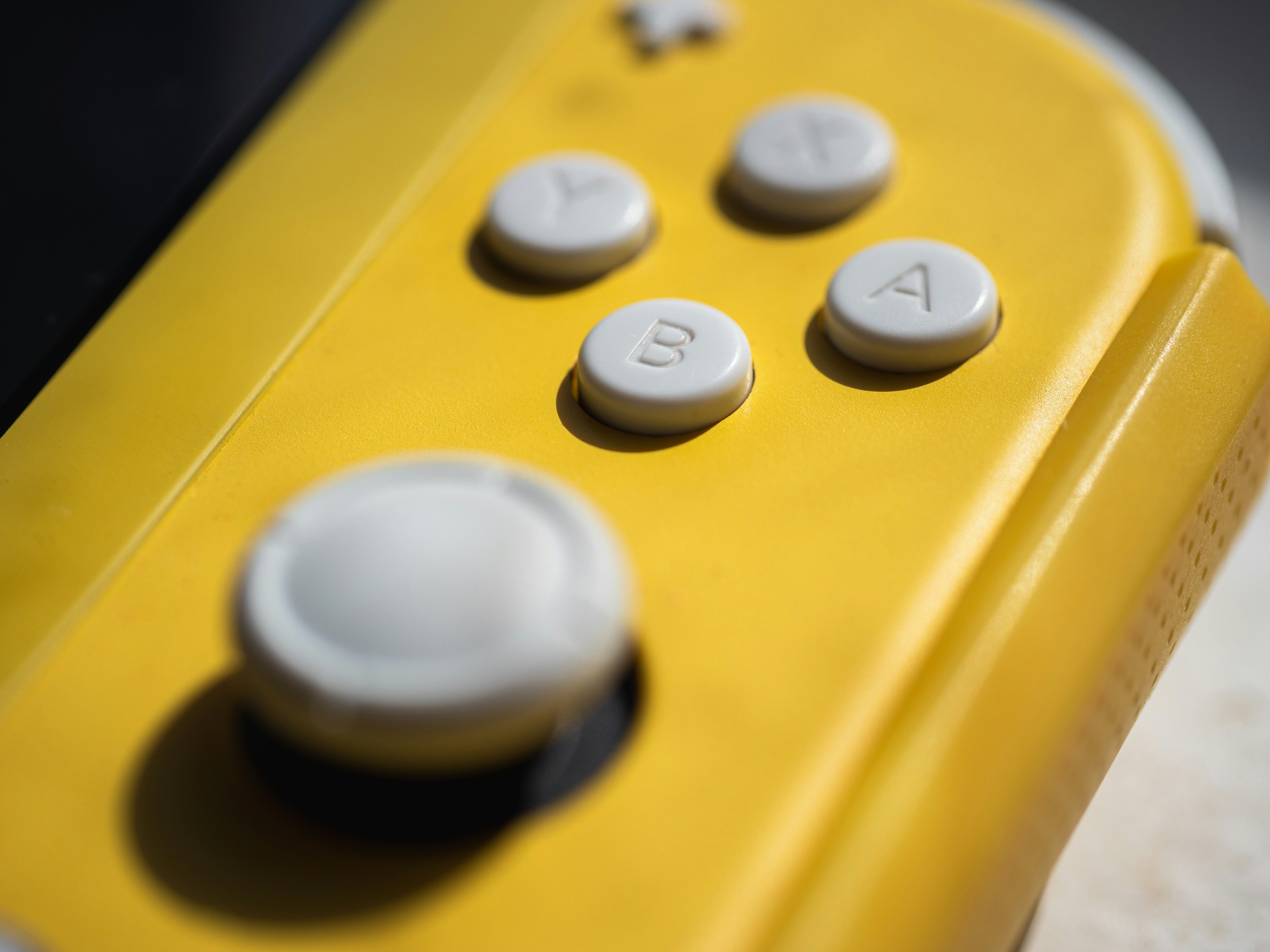 Yellow game controller with visible buttons