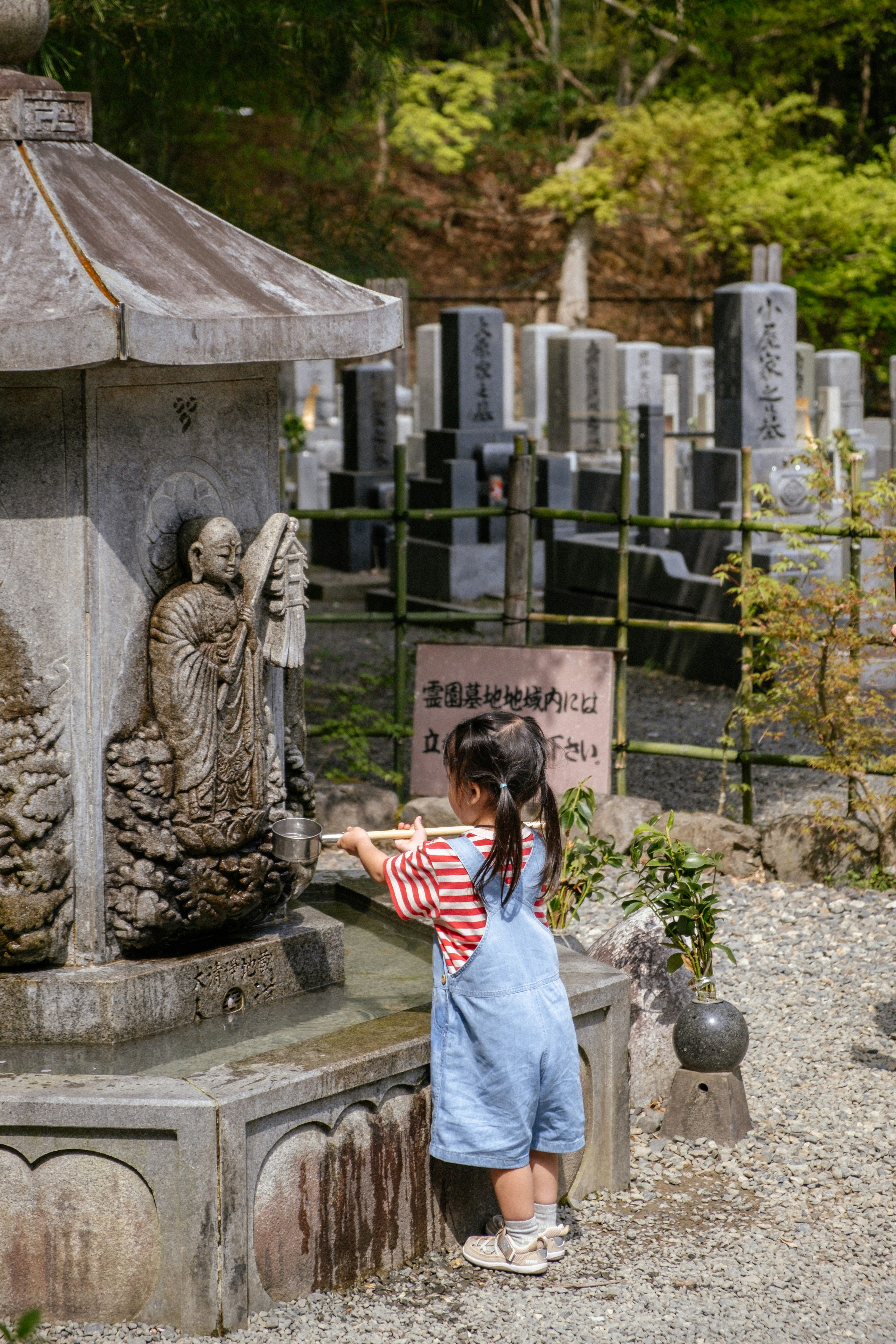 A girl performs a ritual at a japanese shrine.