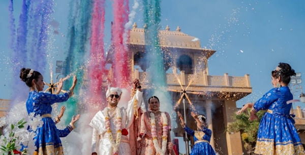 Guests celebrate a wedding with colorful explosions.