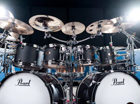 A black pearl drum set is ready to be played.