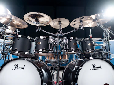 A black pearl drum set is ready to be played.