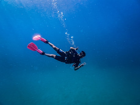 A diver explores the deep blue ocean.