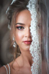 A beautiful bride poses, partially veiled