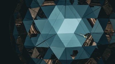 Abstract blue geometric pattern with building reflections.
