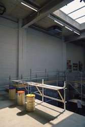 An industrial space with benches and scaffolding.