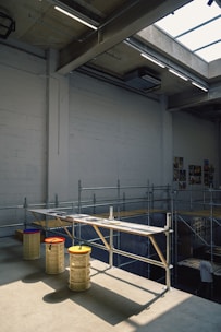 An industrial space with benches and scaffolding.