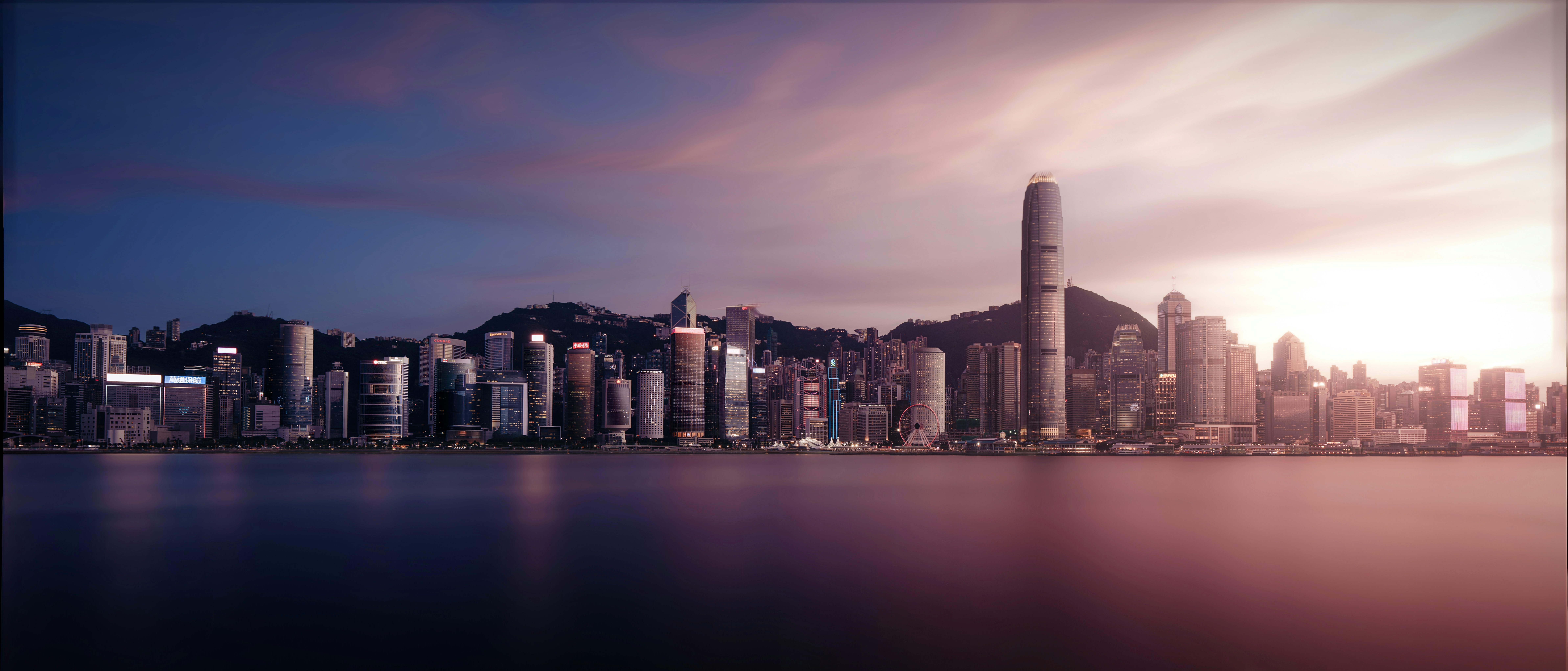 City skyline at dusk reflecting on the water.