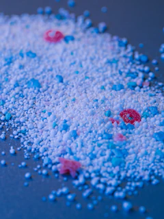 Colored granular substance is scattered on a surface.