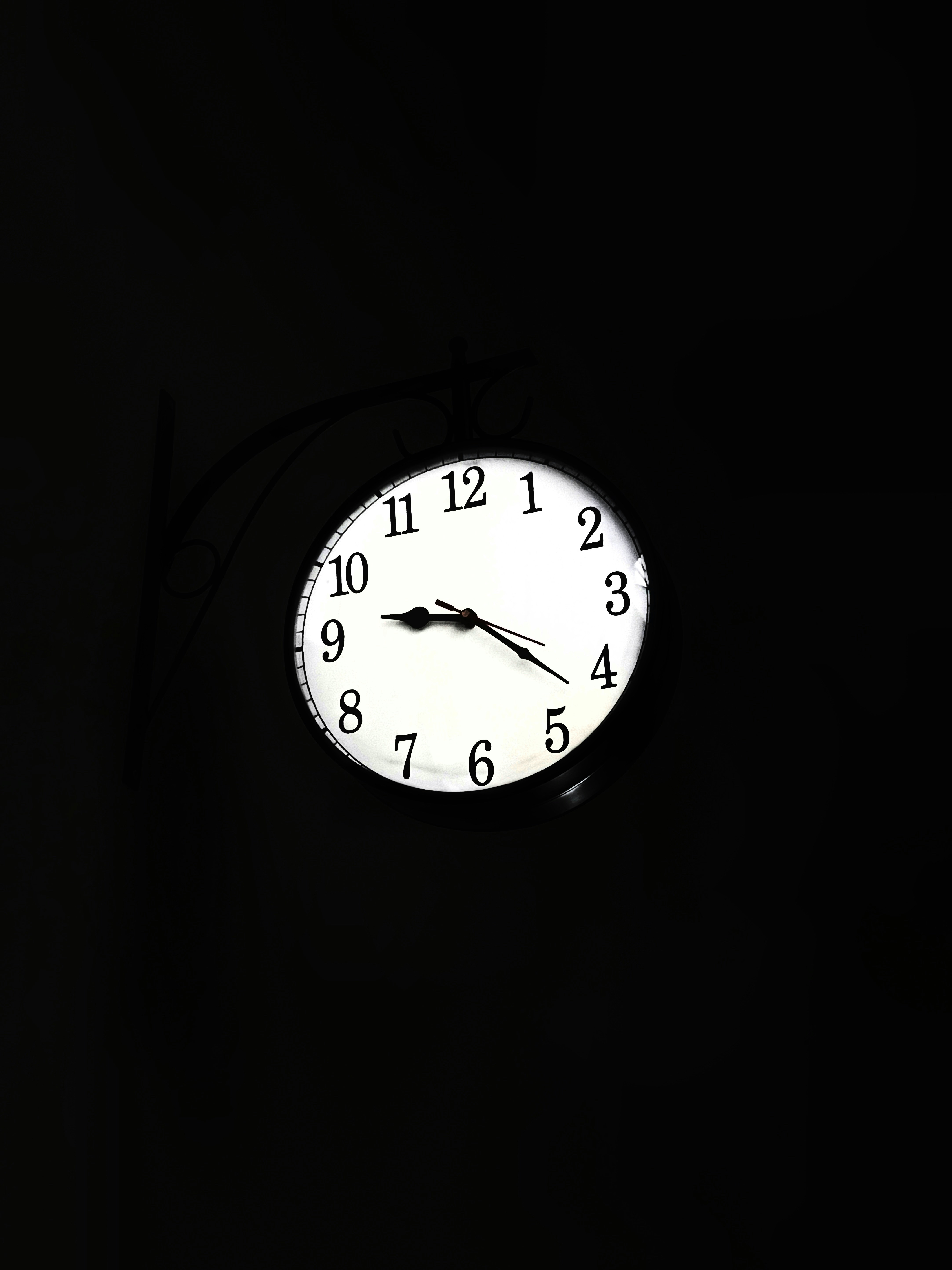 A clock illuminated in the dark.