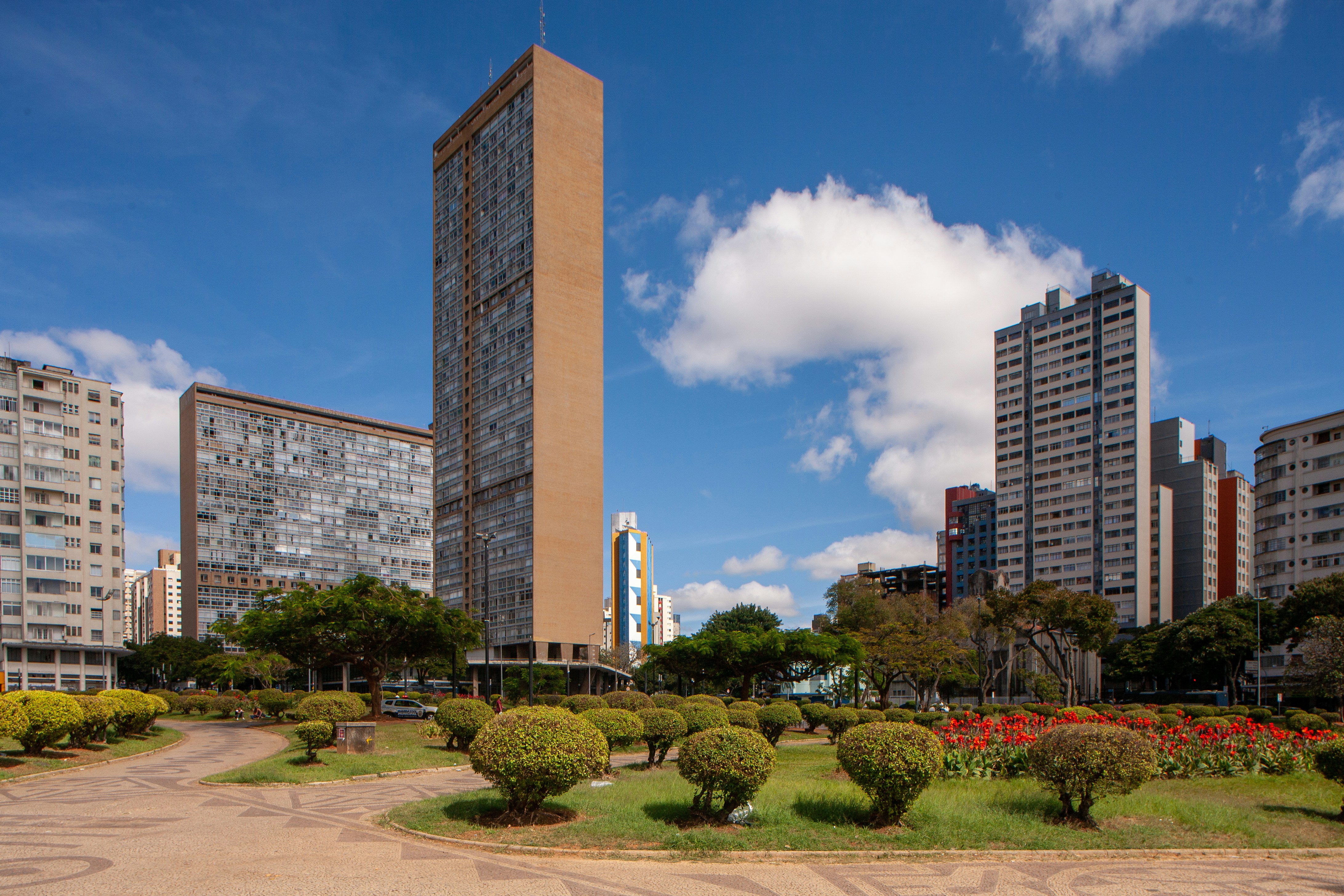 Modern buildings stand in a park on a sunny day.