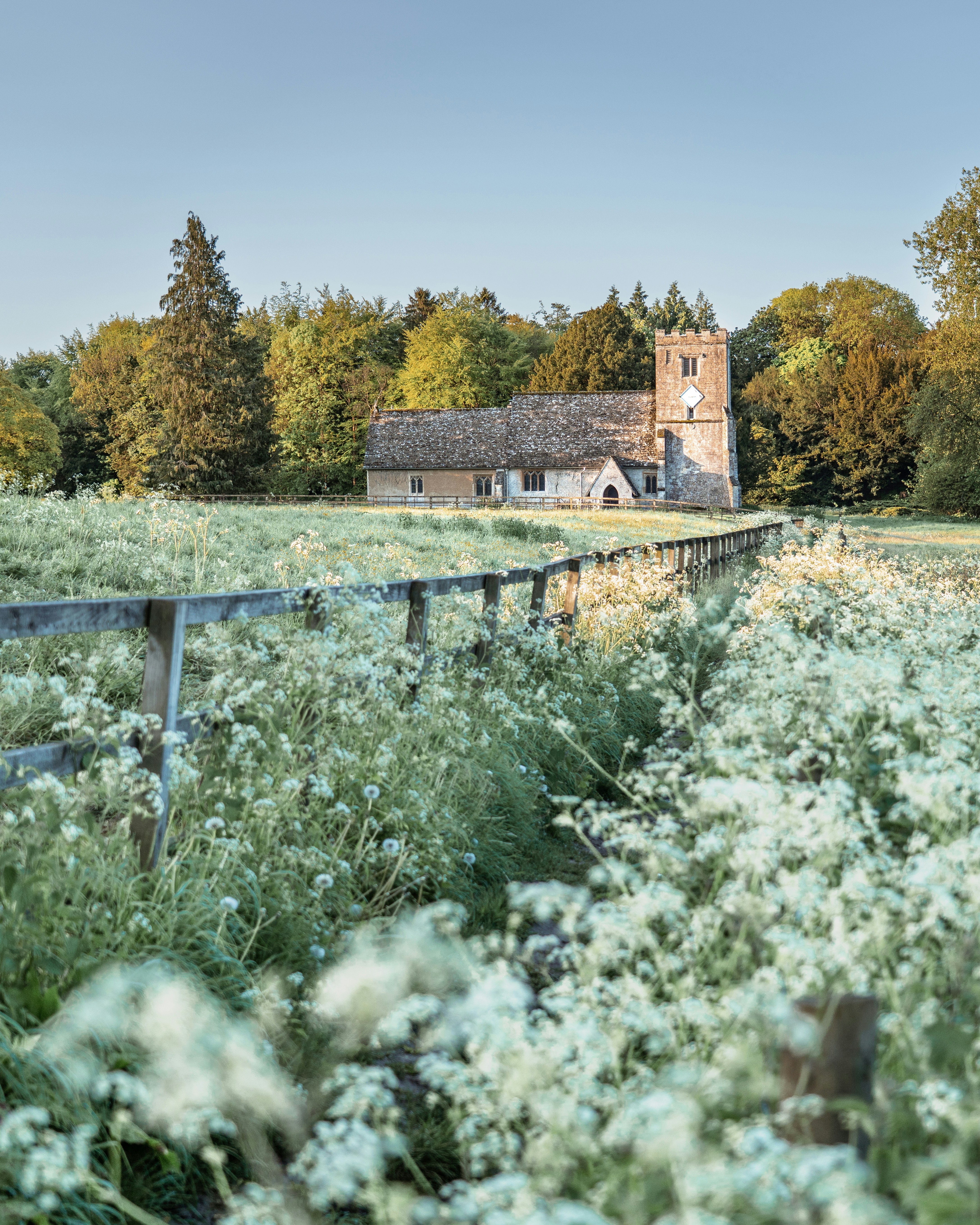 Church in the countryside behind a flower-filled fence