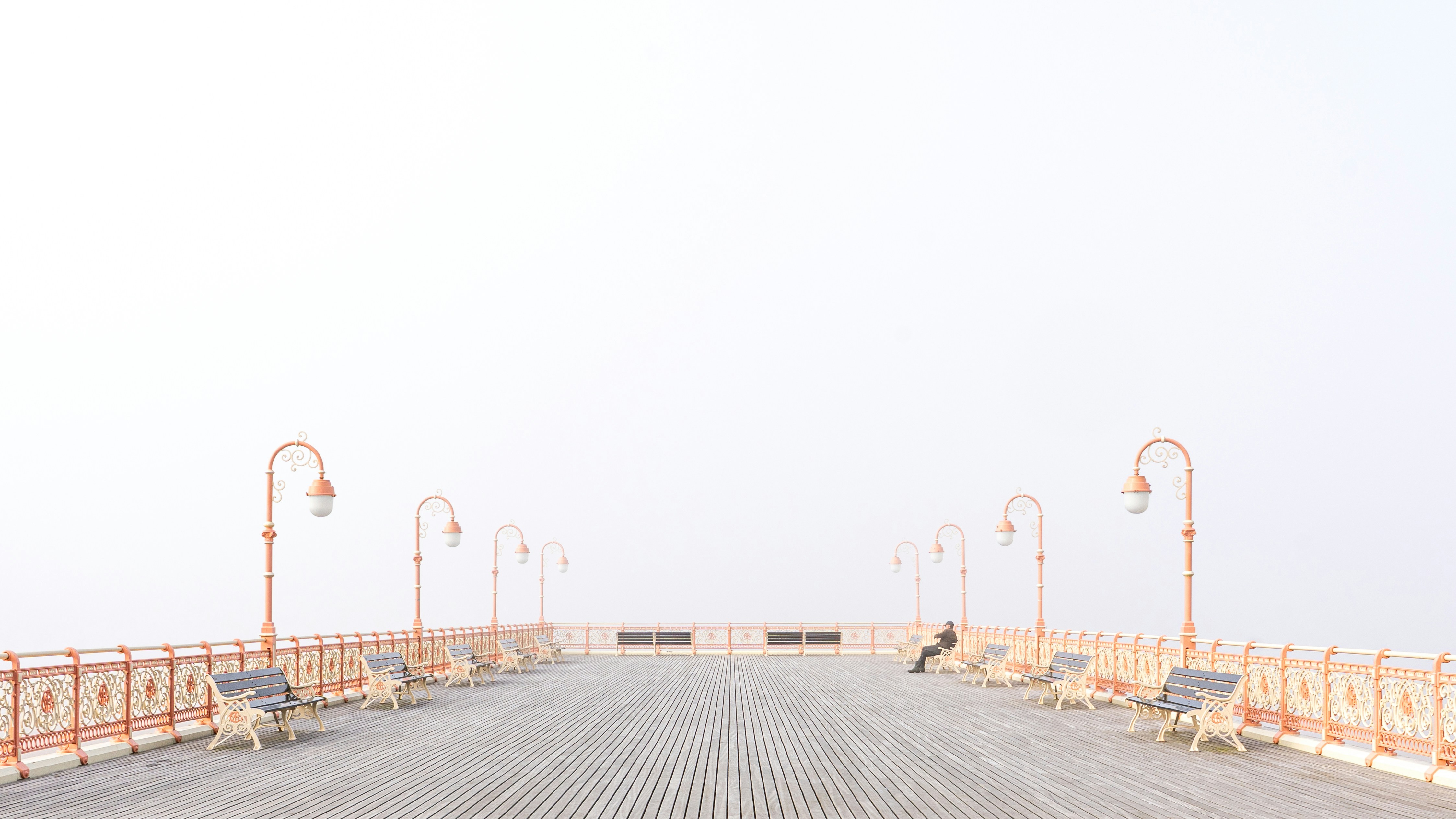 A pier with lamps in the fog