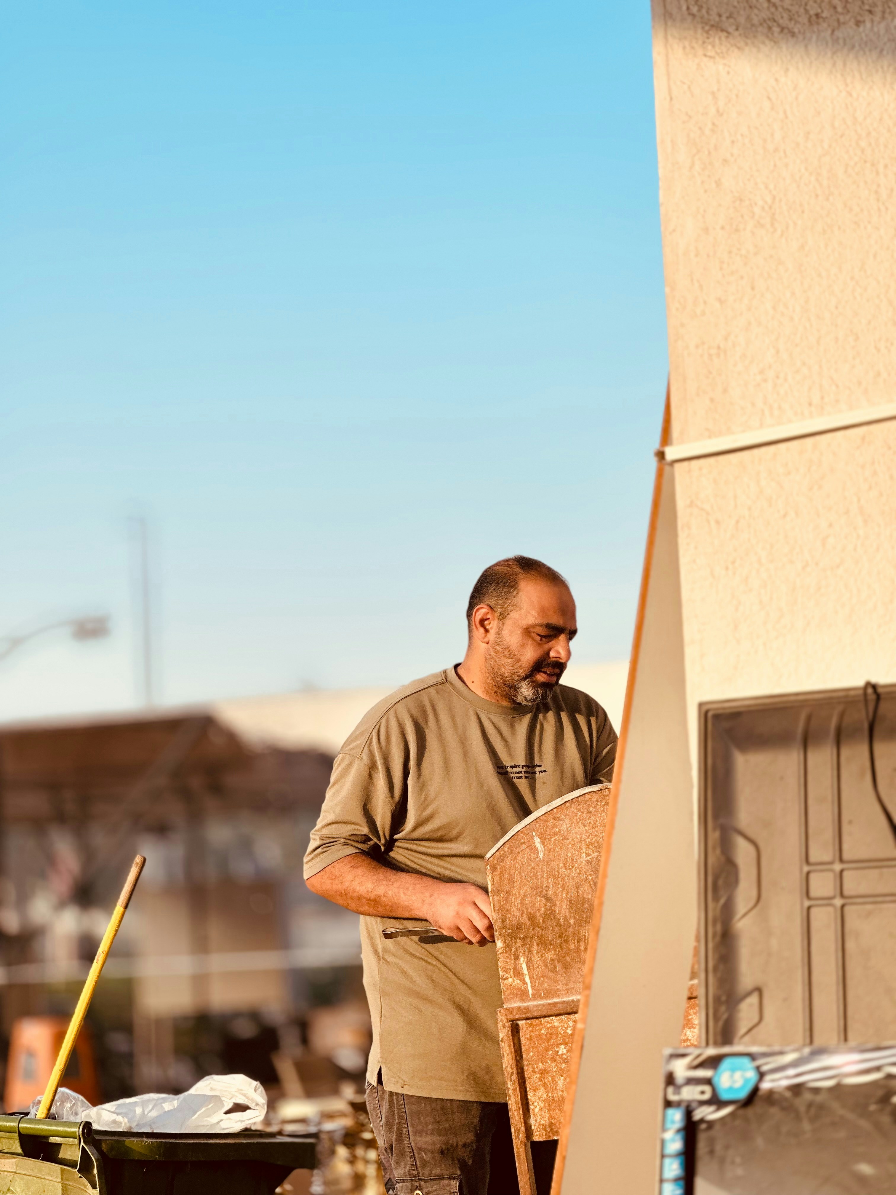 HVAC technician inspecting an outdoor air conditioning unit on a sunny day