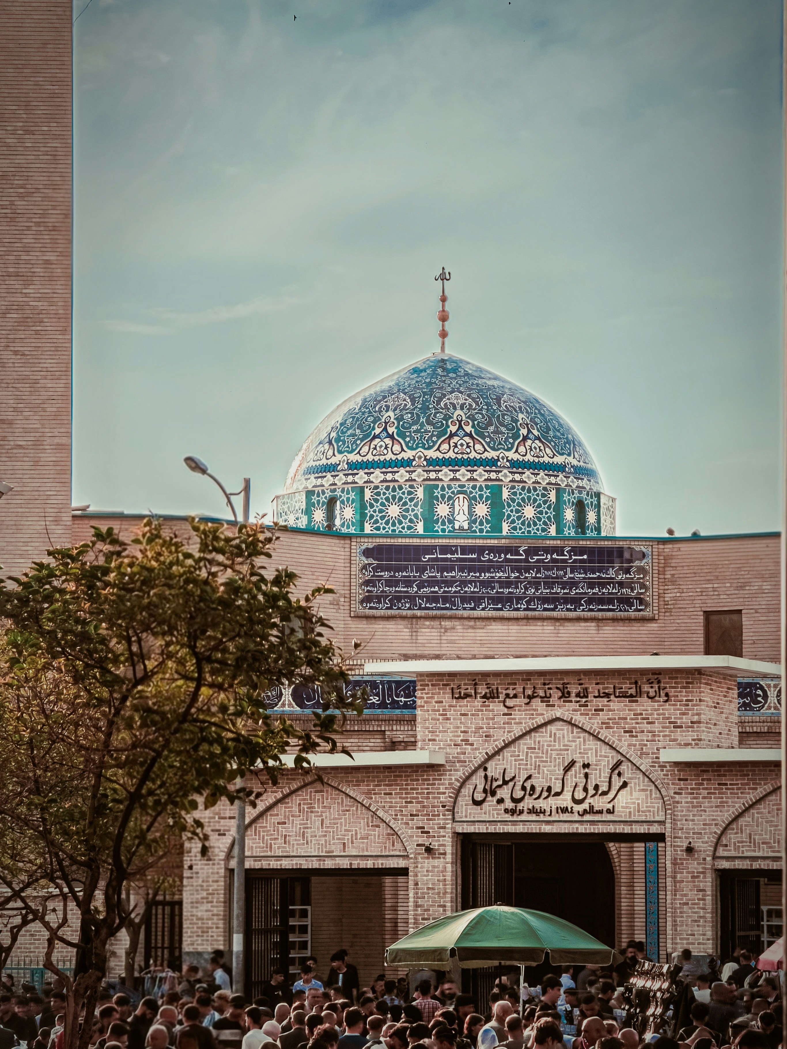 A beautiful mosque dome against a cloudy sky.