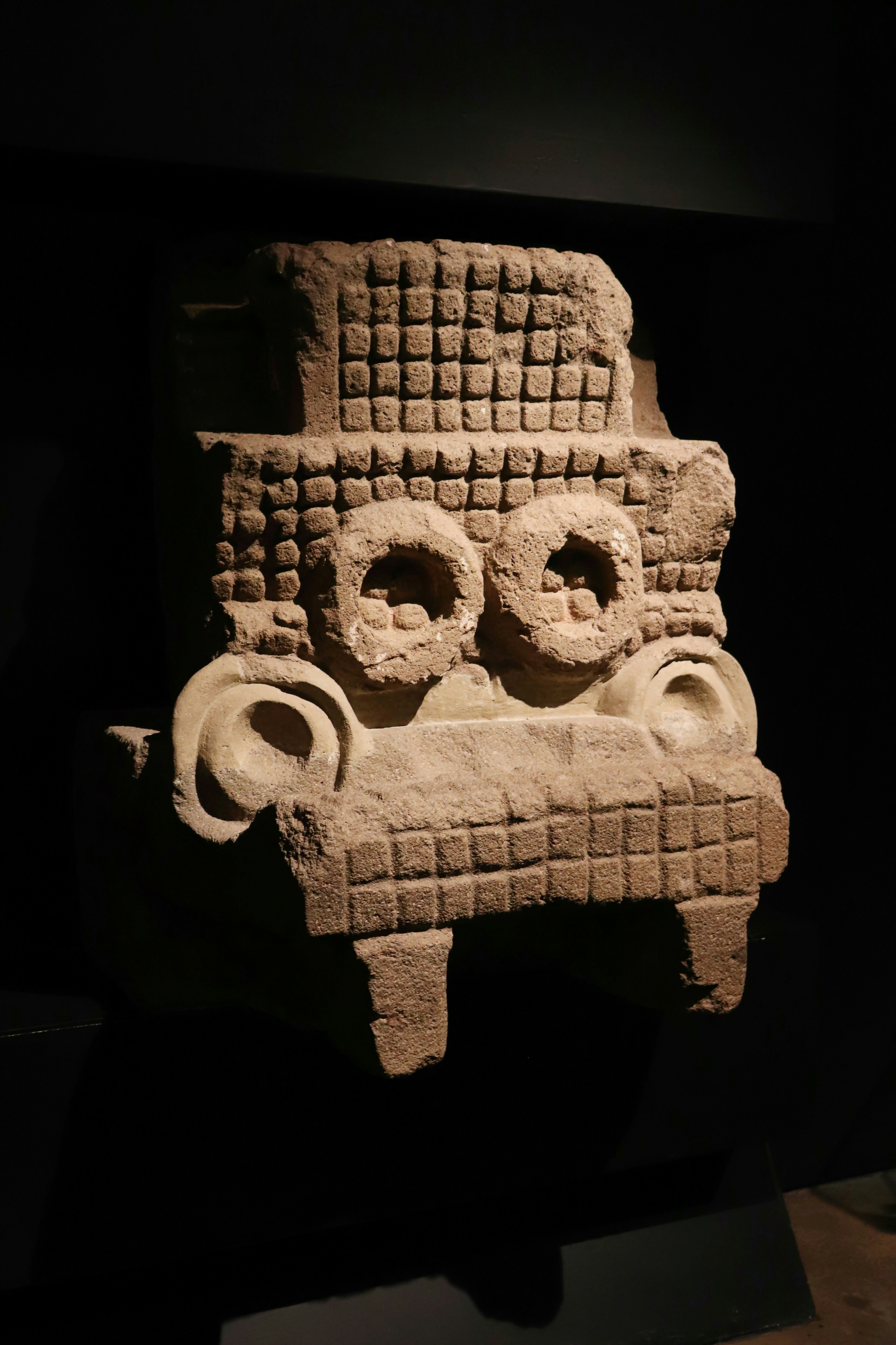 An ancient stone carving is displayed.