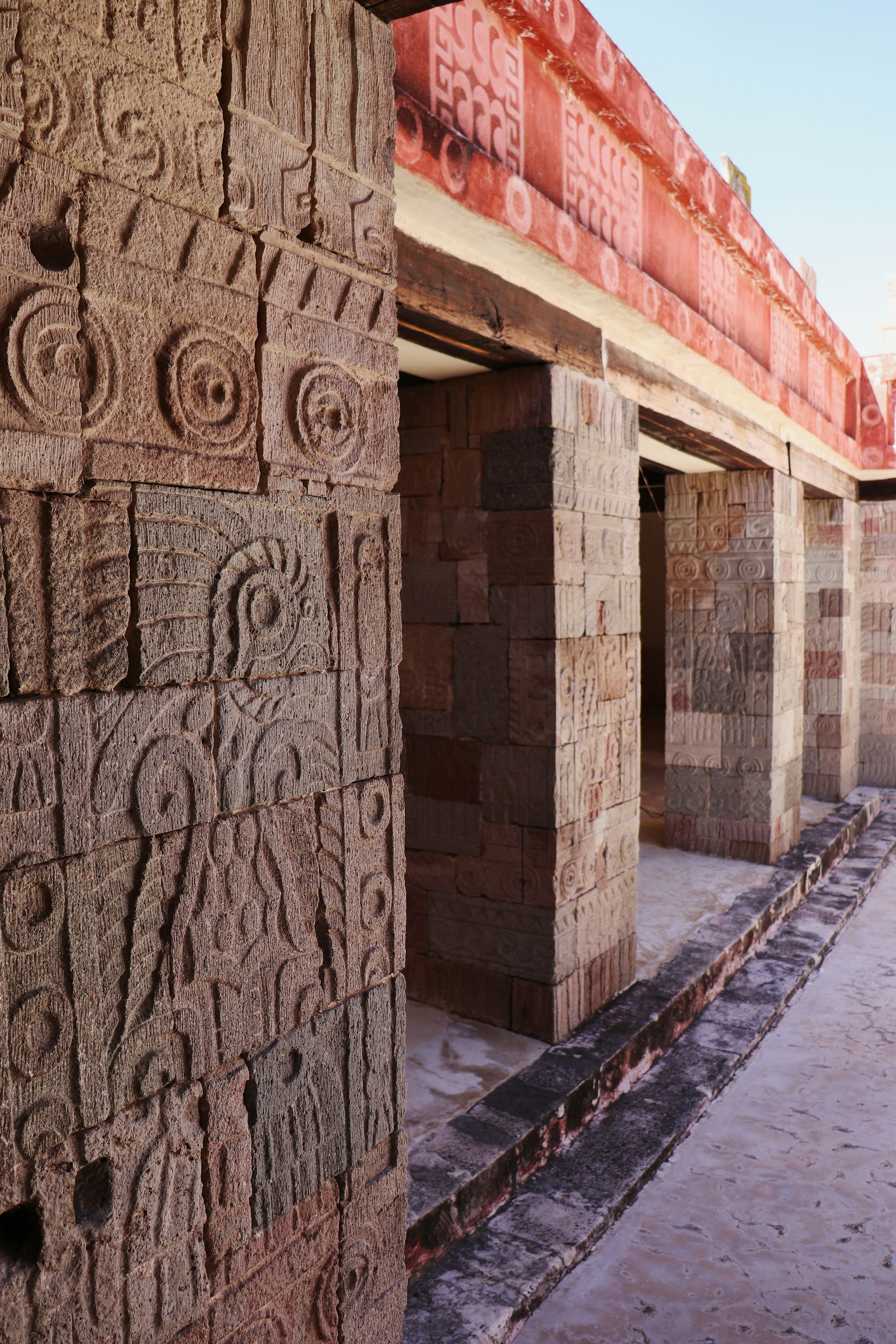 Ancient carvings adorn the pillars of a structure.