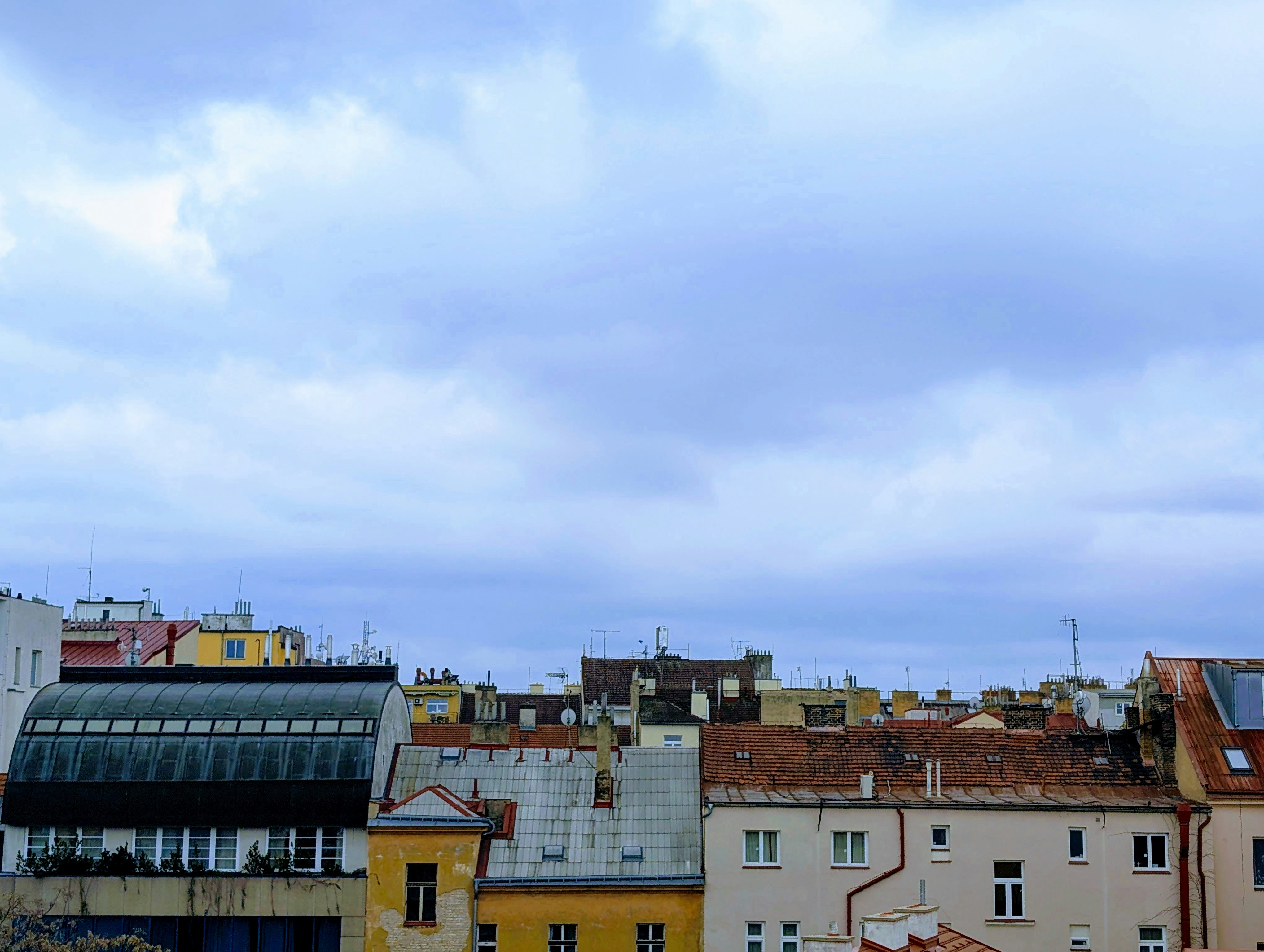 Buildings are seen under a cloudy sky.