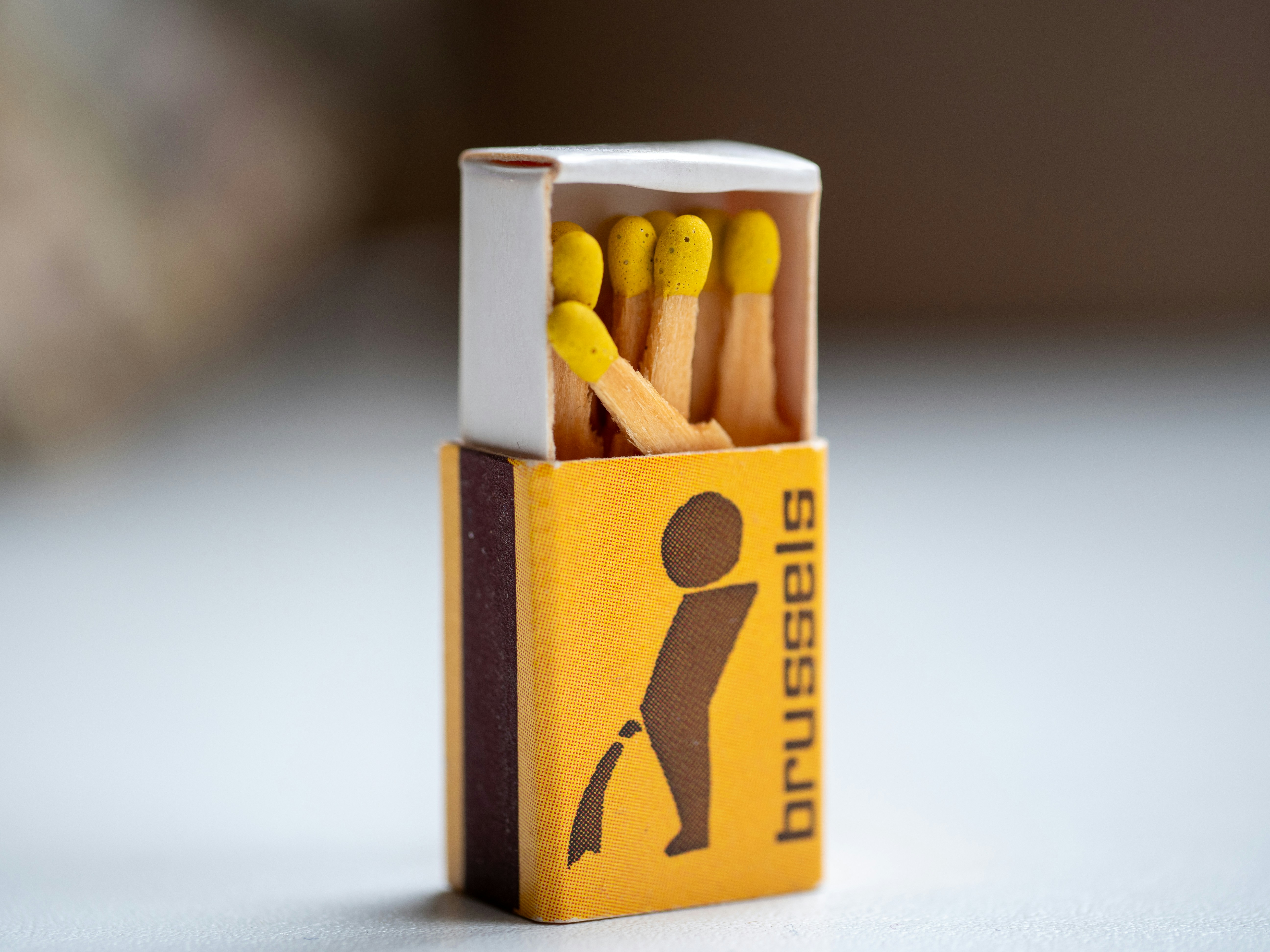 Matchbox featuring a funny brussels illustration.
