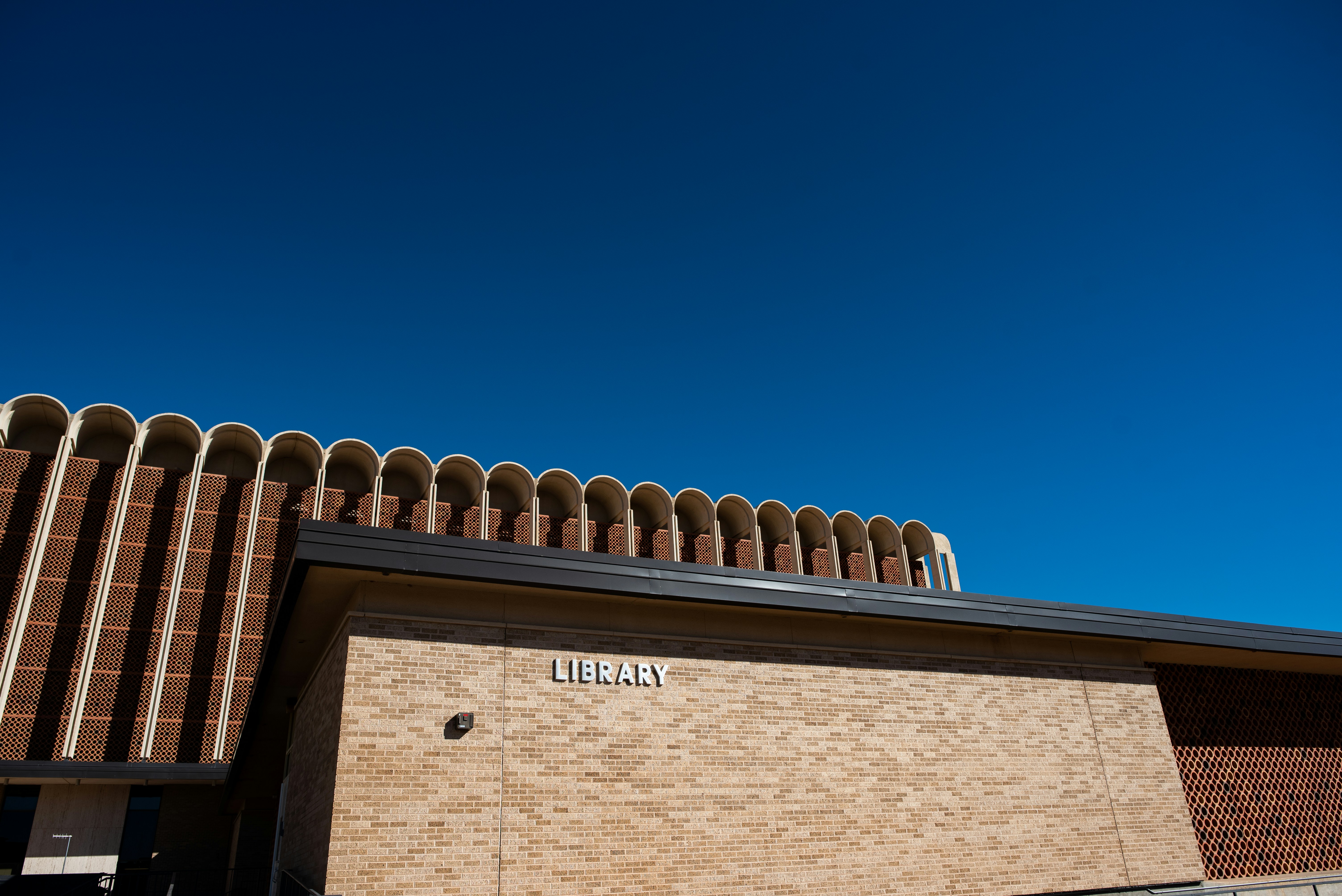 Building exterior under a vibrant, blue sky.