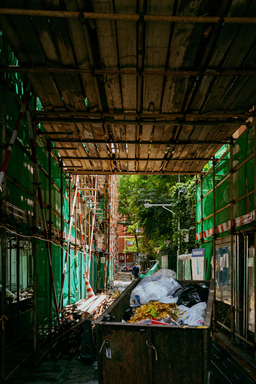 Site cleanout — dumpster loaded with debris at a construction job site