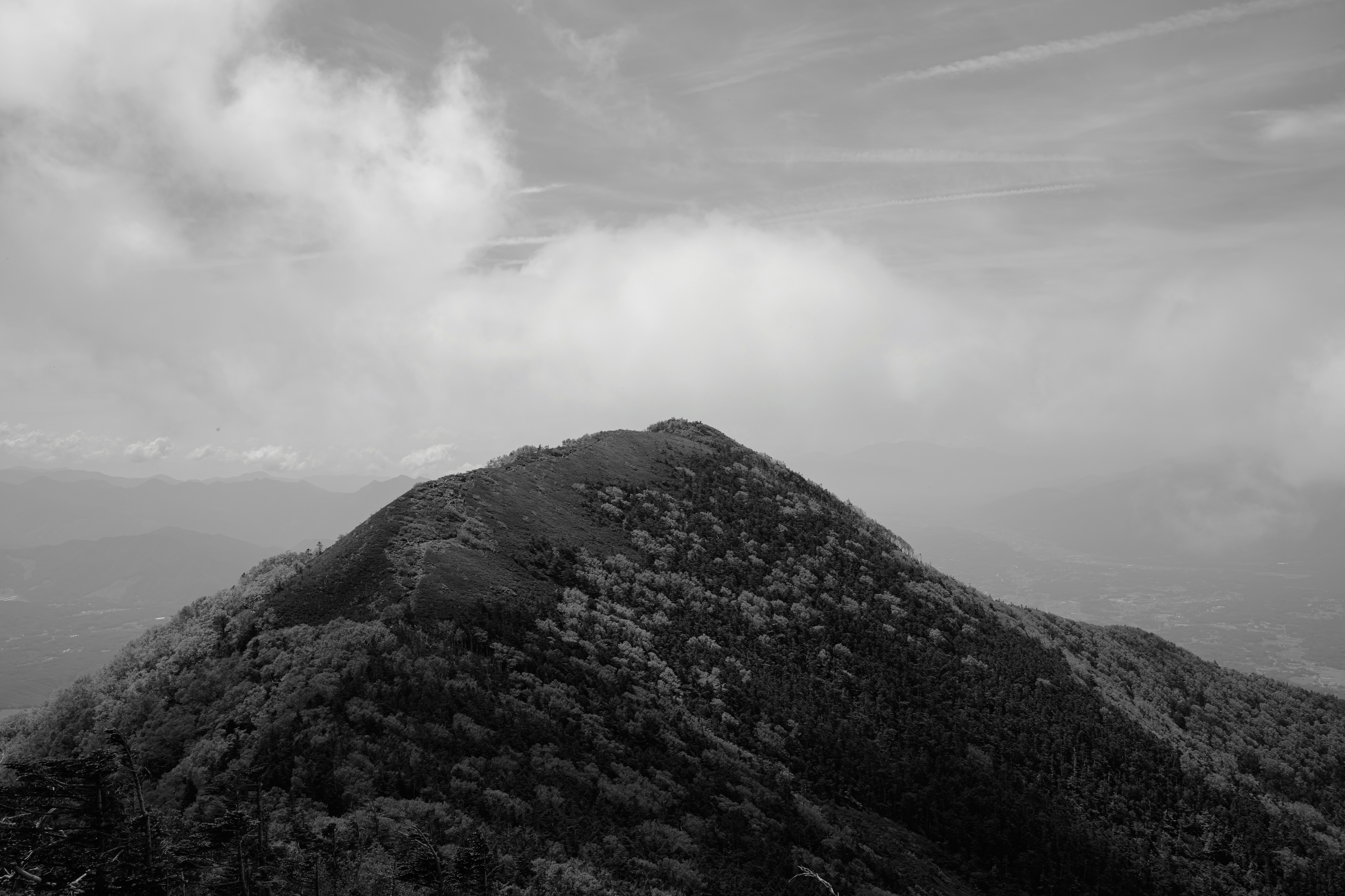 A mountain peak underneath a cloudy sky.