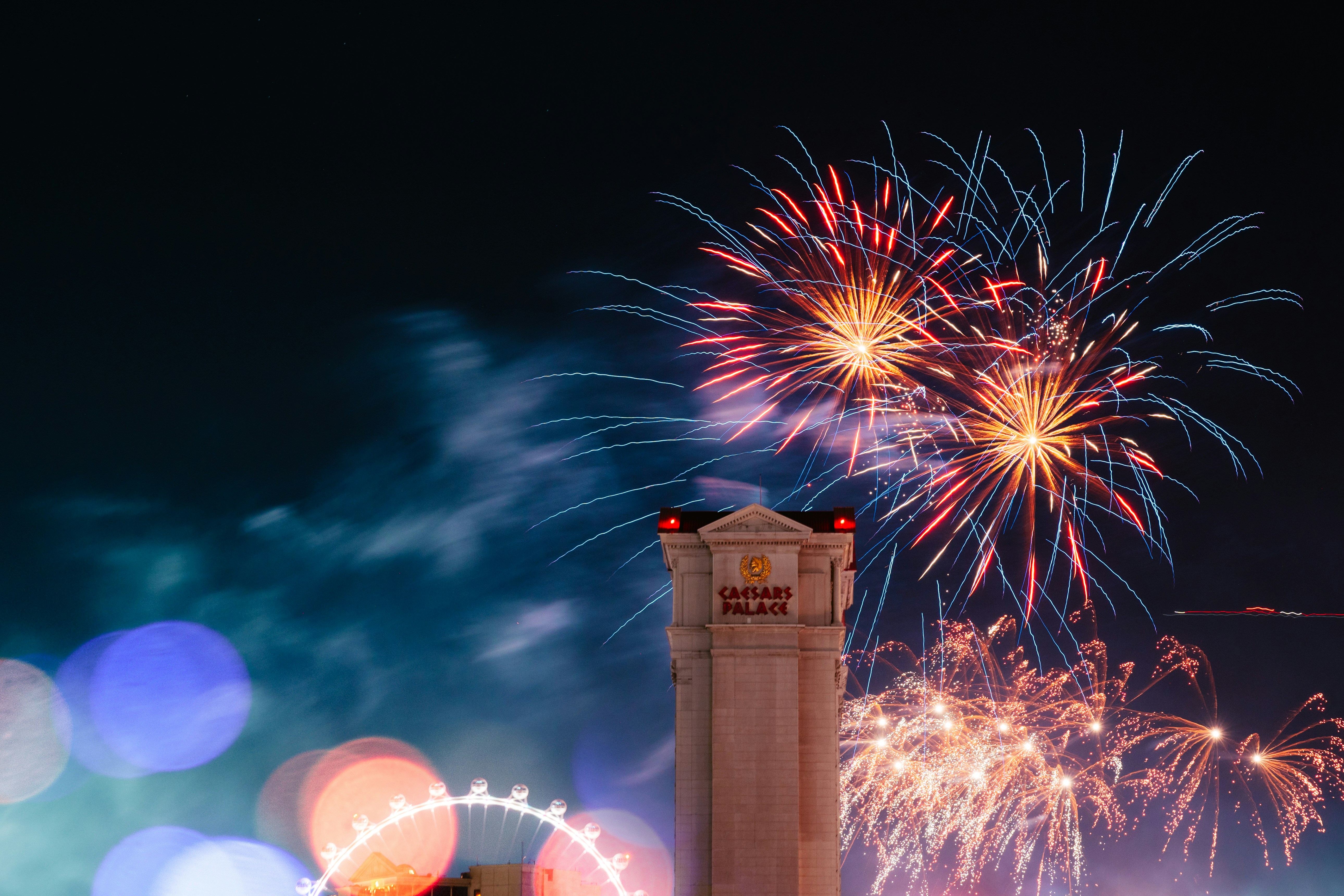 Fireworks explode above a building at night