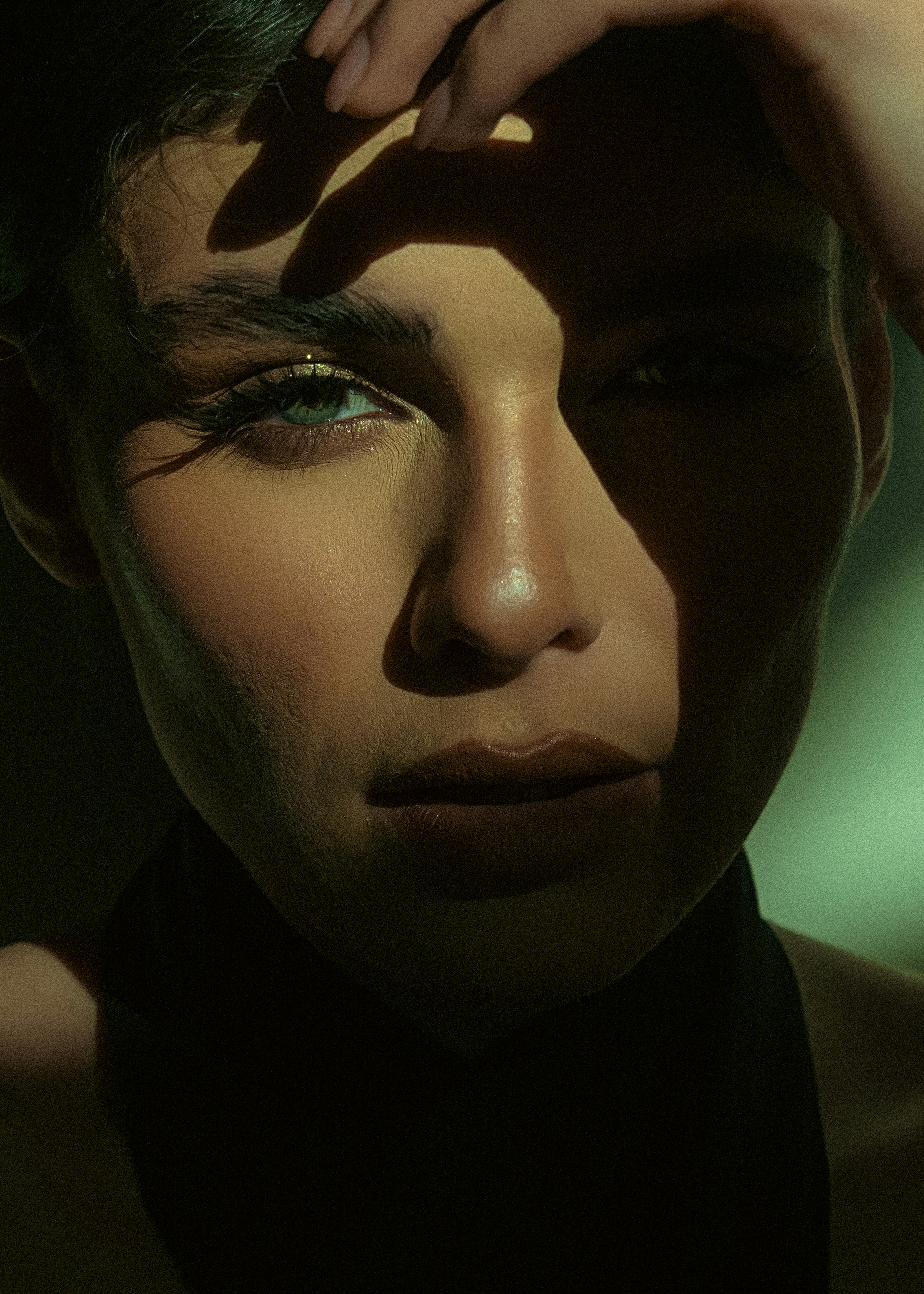 A woman gazes with a shadowed face.