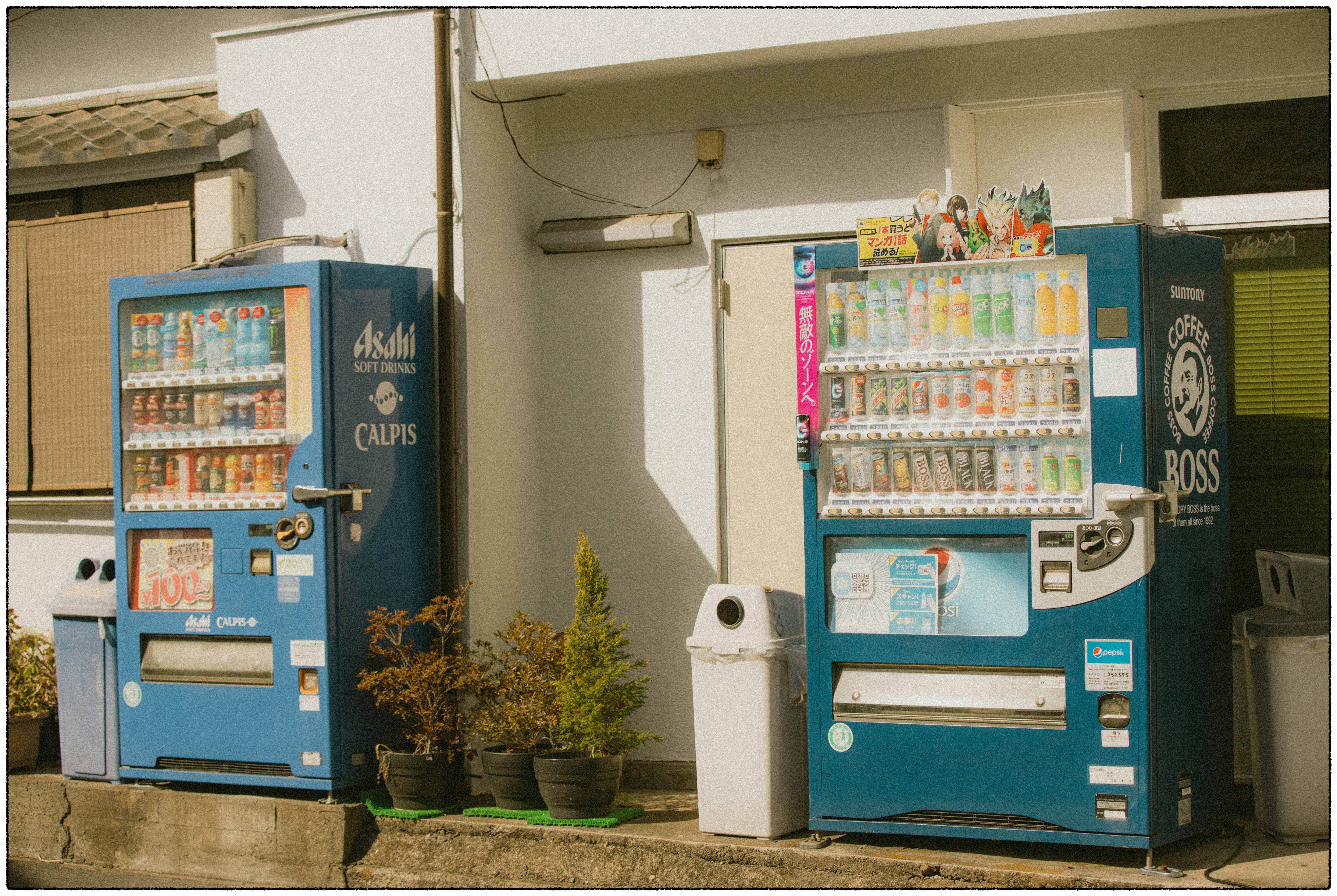 Two self-service beverage vending machines installed outside a building
