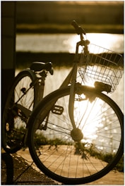 A bicycle silhouetted against a bright sunset.