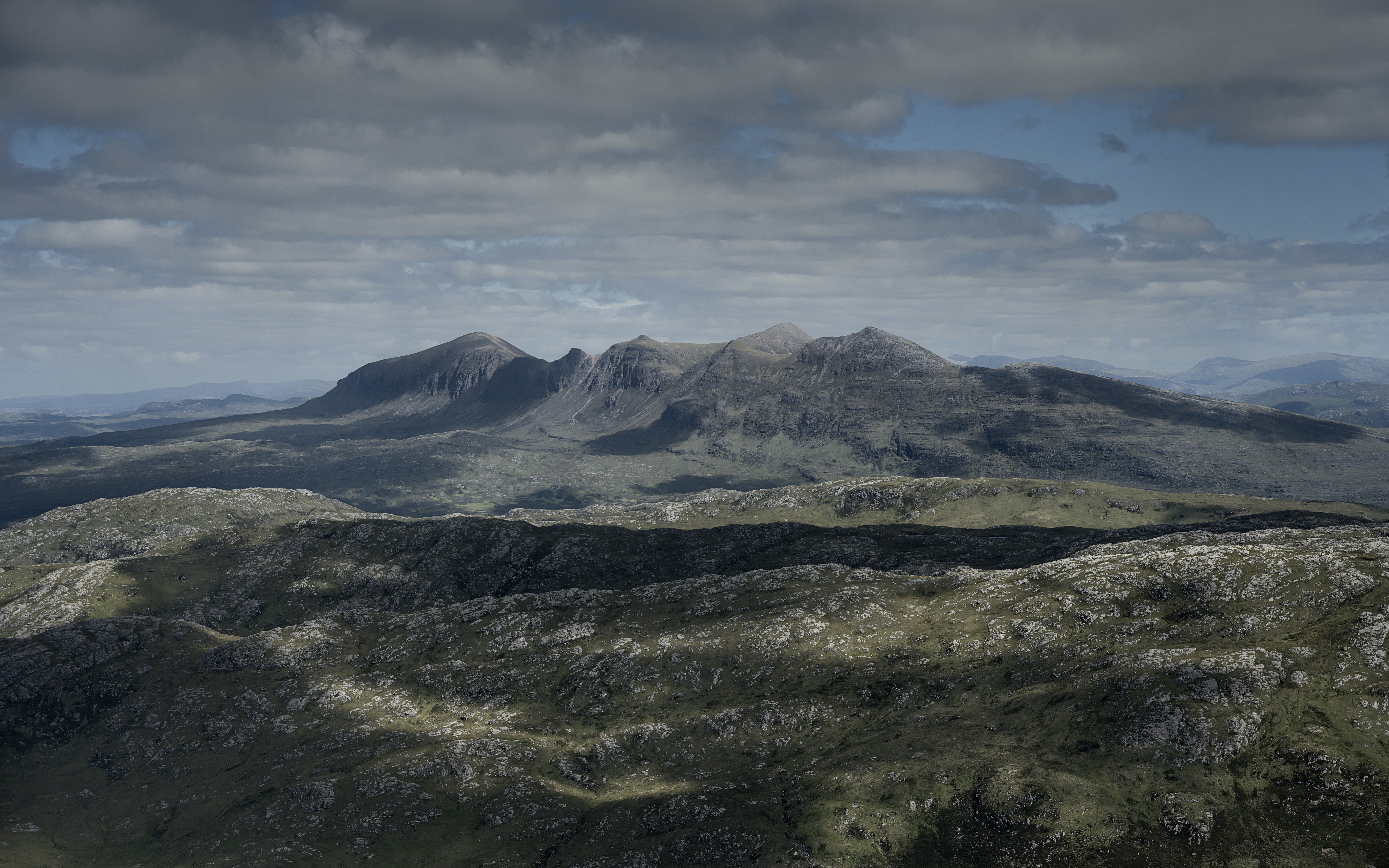 Mountains under a cloudy sky.