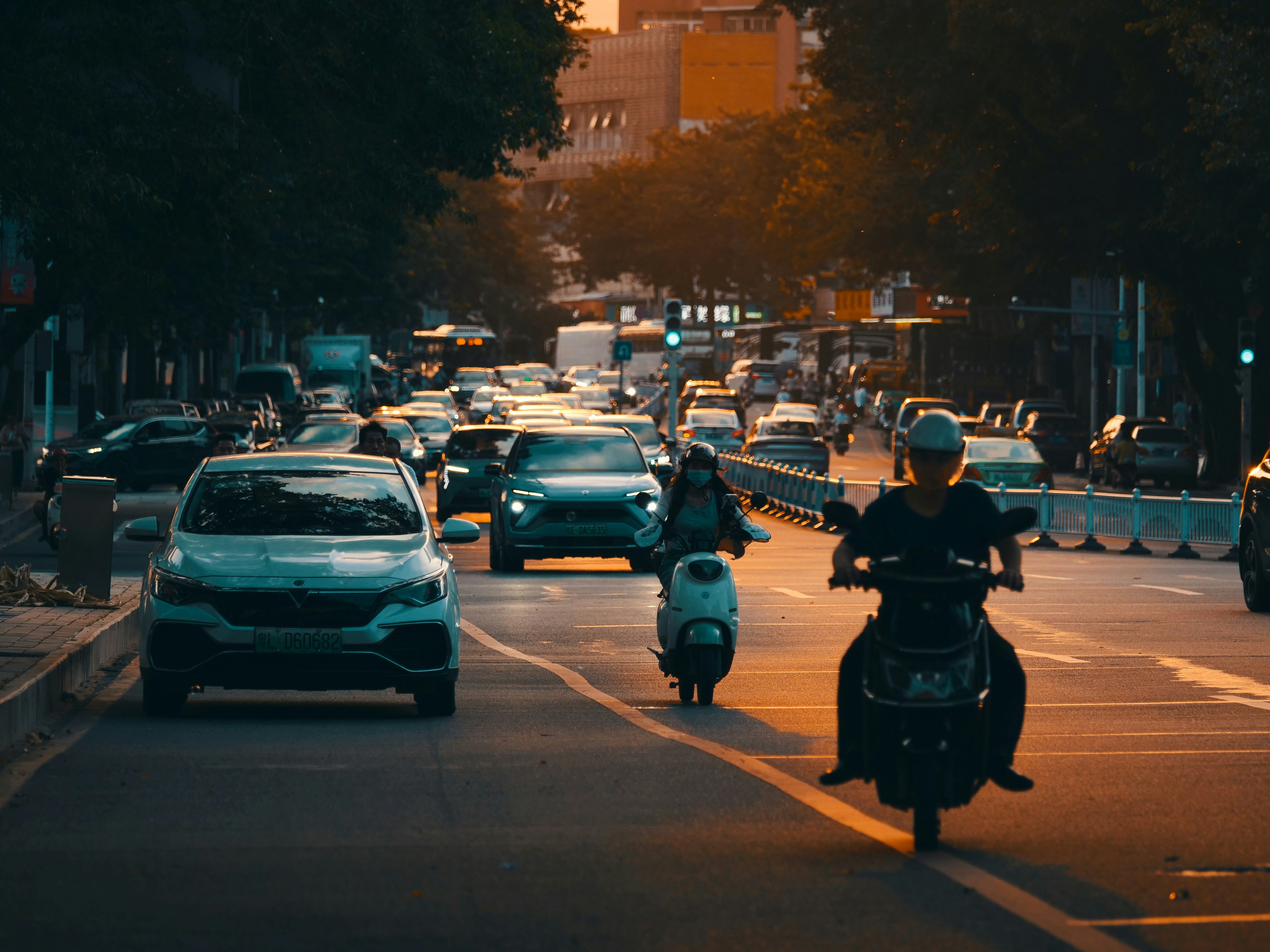 Cars and motorbikes on a busy road.