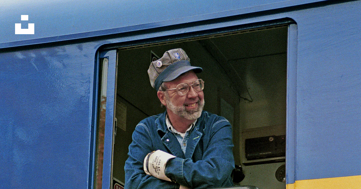 Smiling Train Driver A train driver smiles from the train's window. photo – Free Man Image ...