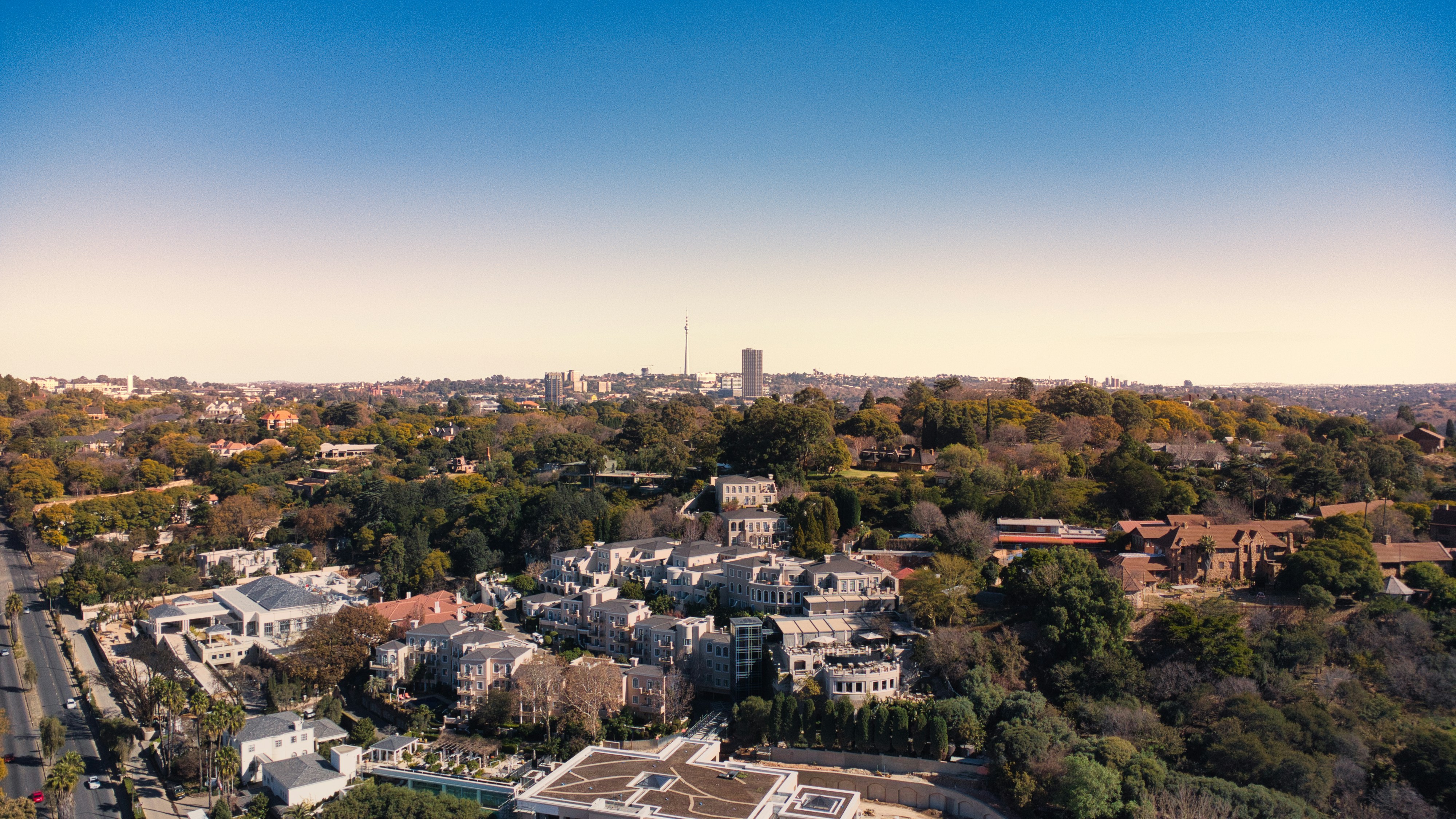 Aerial view of a cityscape under a clear blue sky.