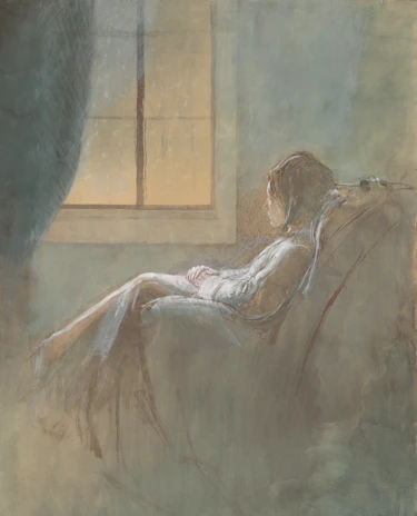 Woman sitting in chair looking out window