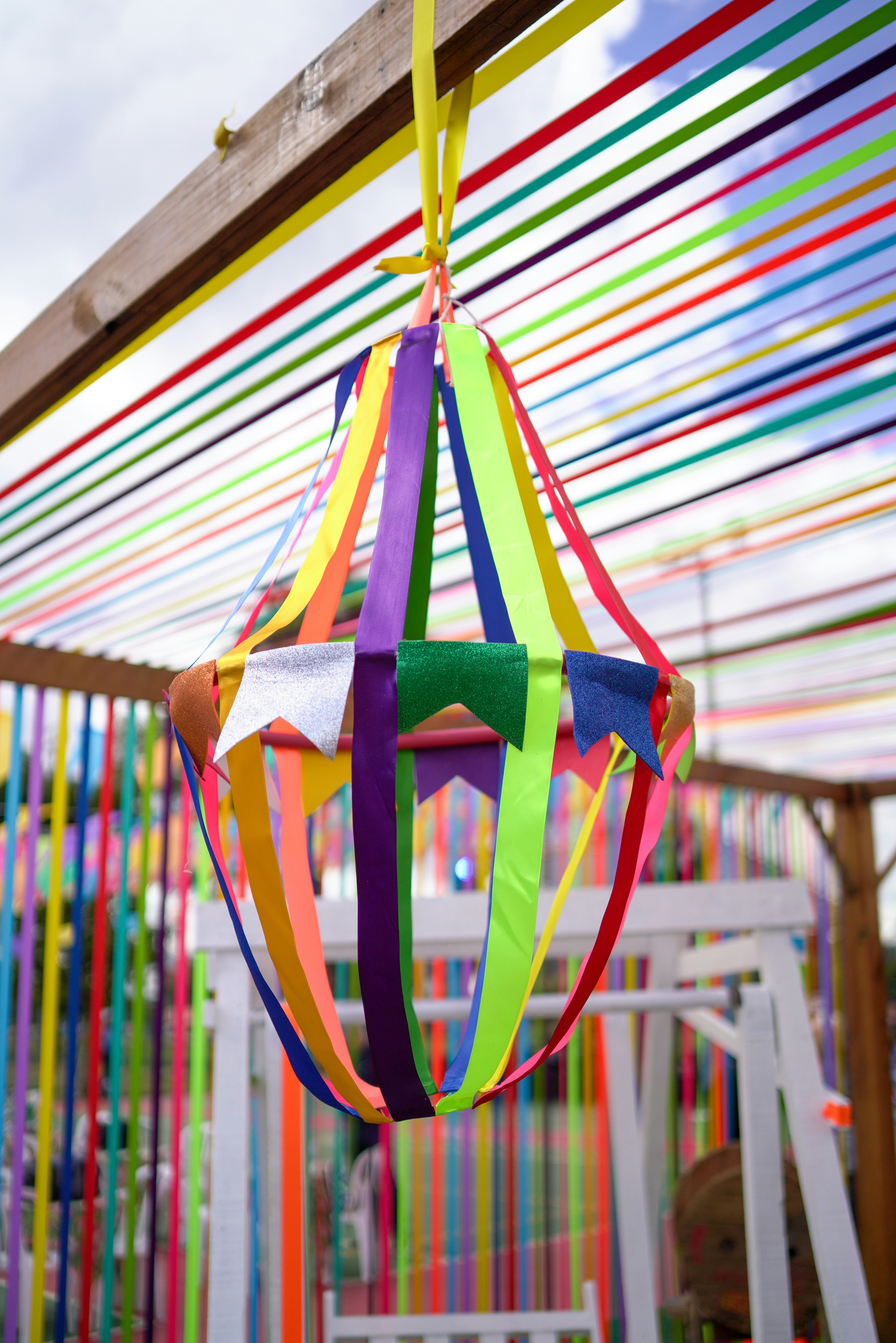 A colorful hanging ornament with ribbons.