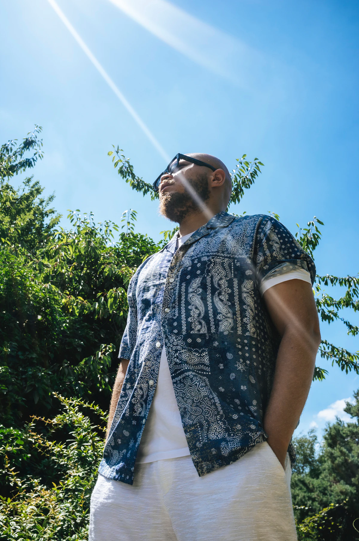 Man standing outdoors in bright sunlight, illustrating vitamin D deficiency and low testosterone in men.