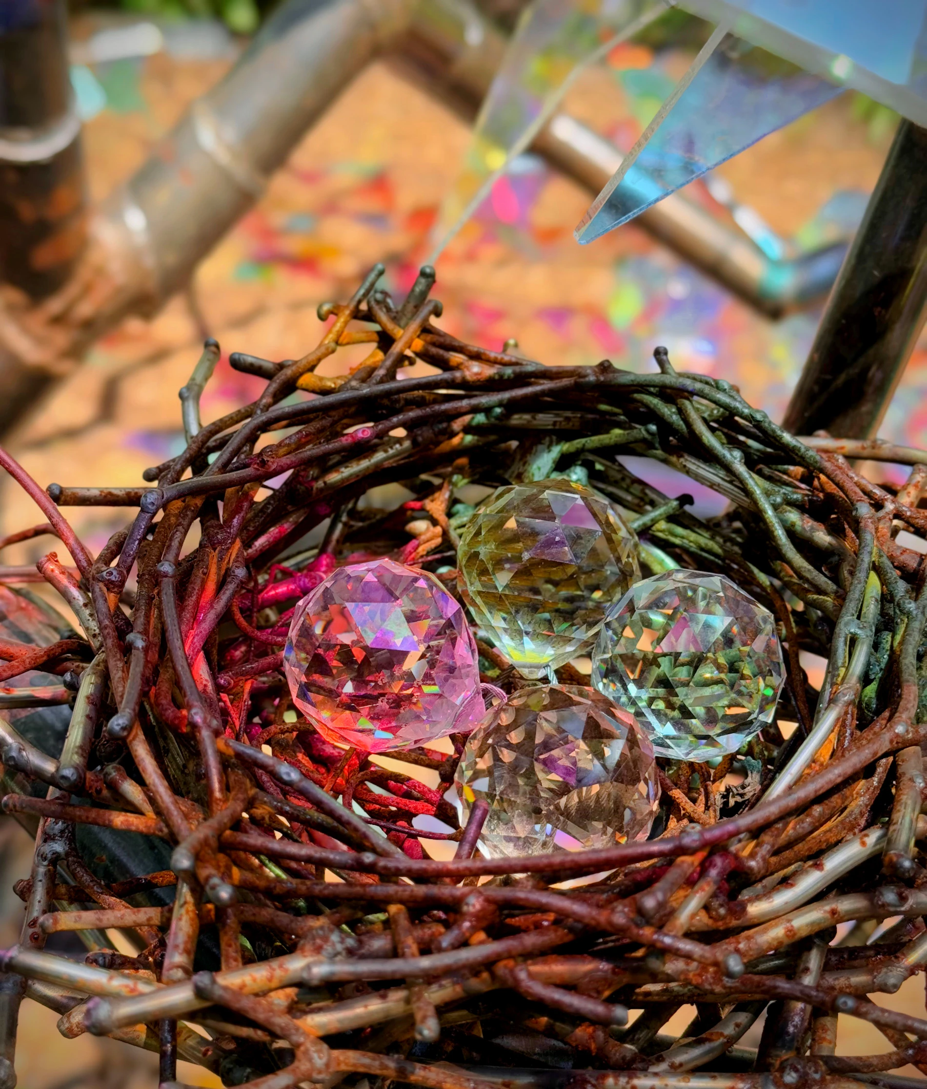 Finished glass pieces resting in a nest of woven branches