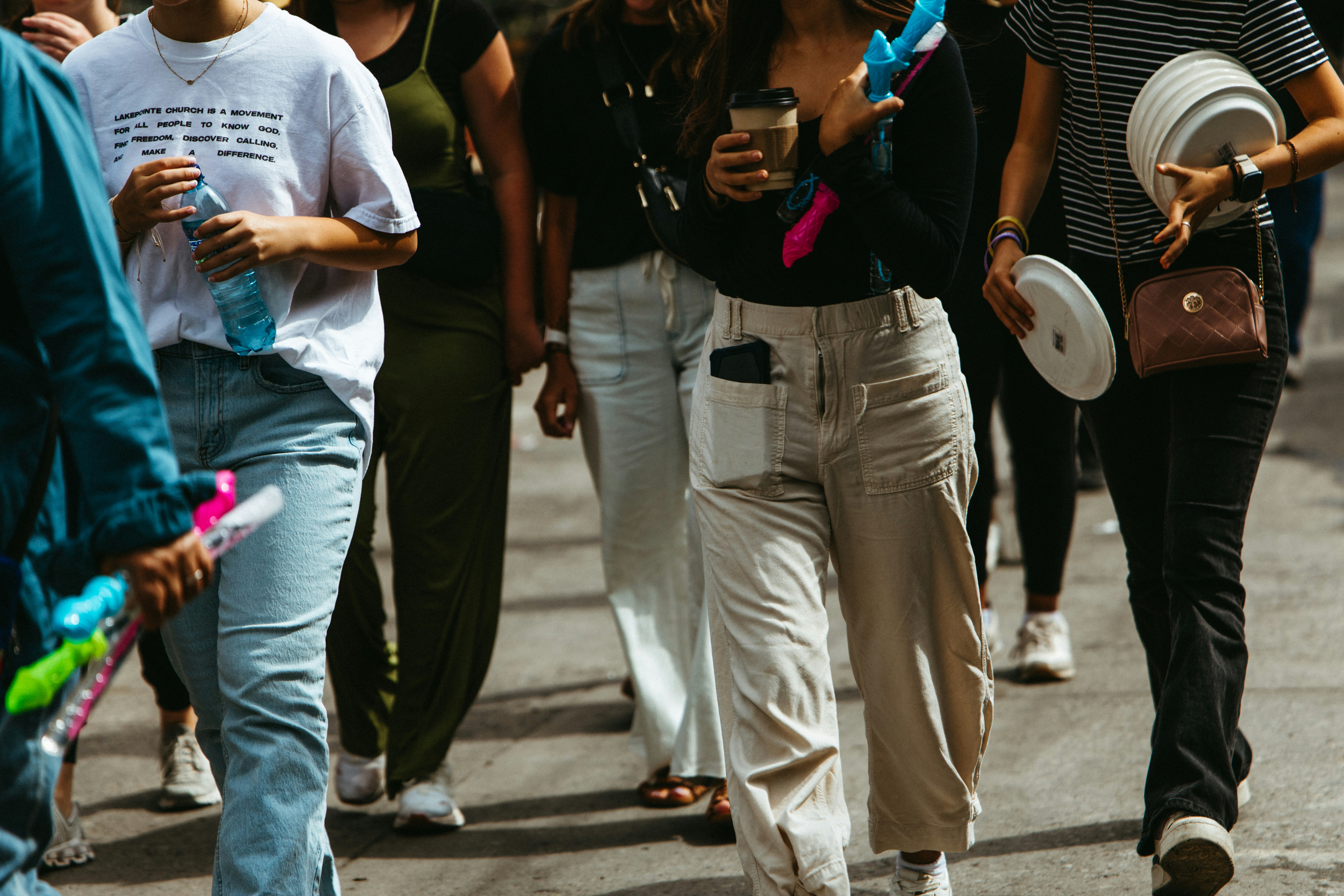People are walking down a street together.