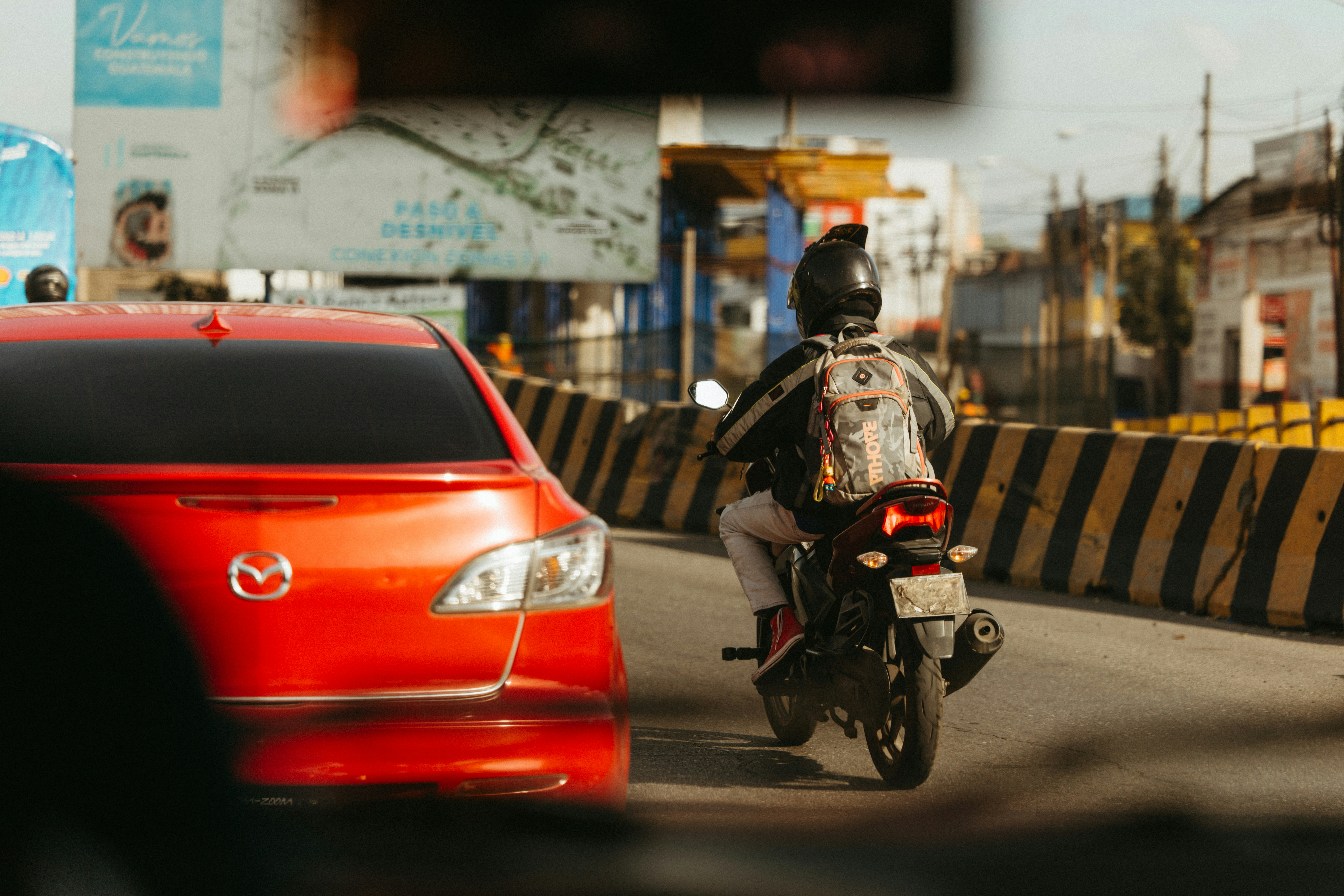 A motorcyclist is riding down a busy road.