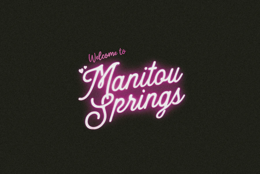Welcome to Manitou Springs sign glowing at night