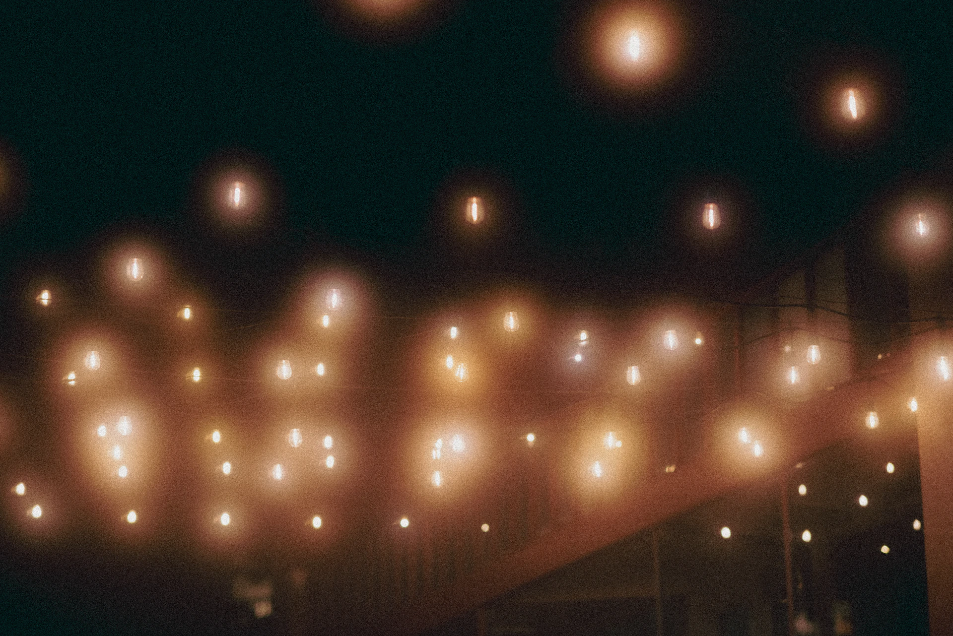 String lights illuminate a dark evening setting.