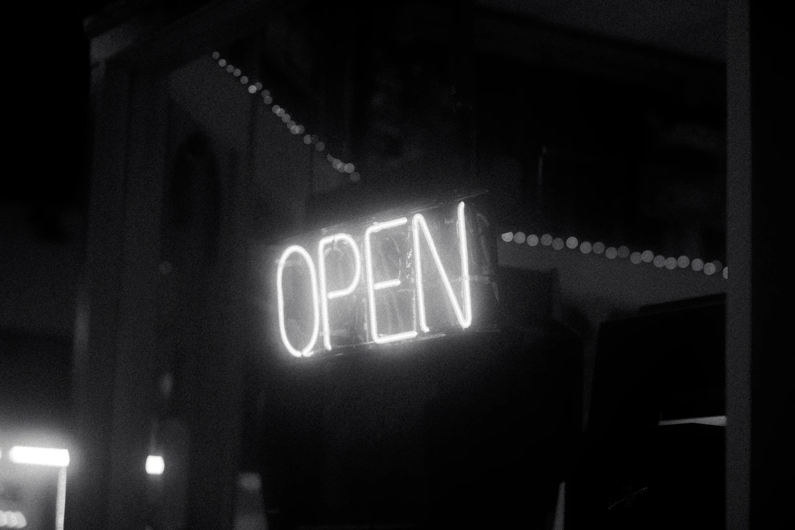 Red neon open sign glowing at night, symbolizing a local business being recommended in AI answers like best dentist near me