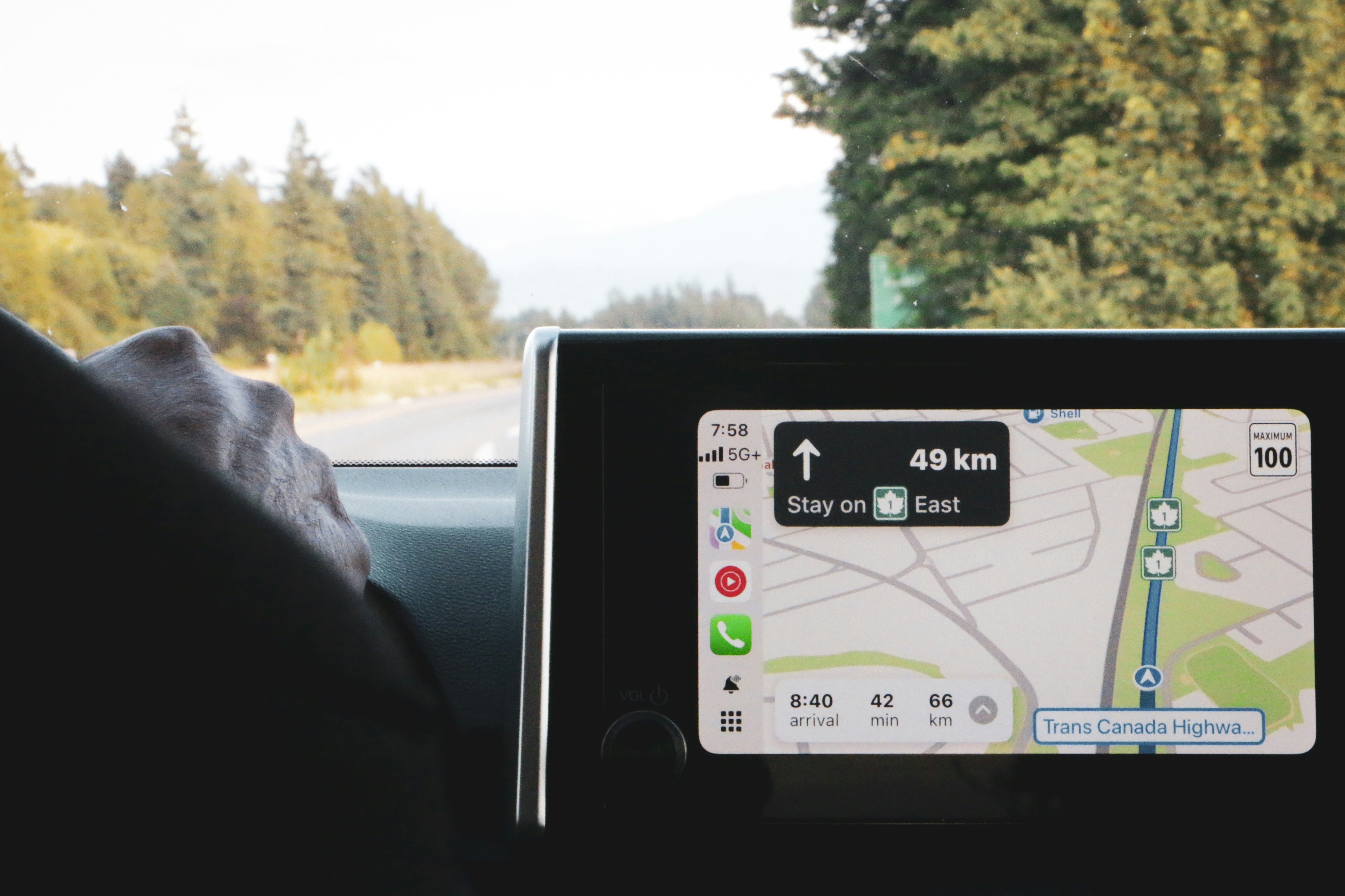 iPhone running Apple Maps navigation on dashboard