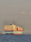 A large container ship sails on the ocean.