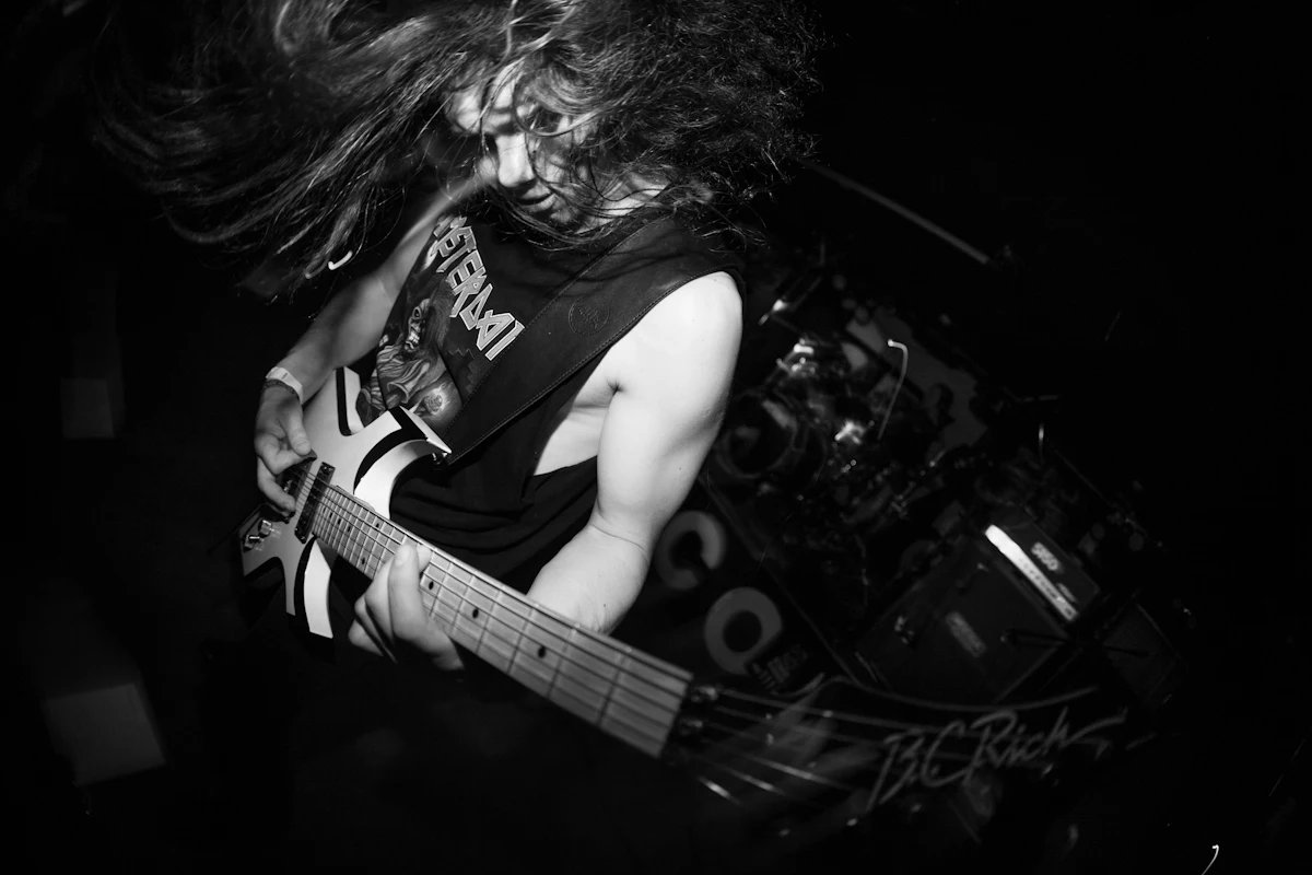 A guitarist headbanging, in black and white