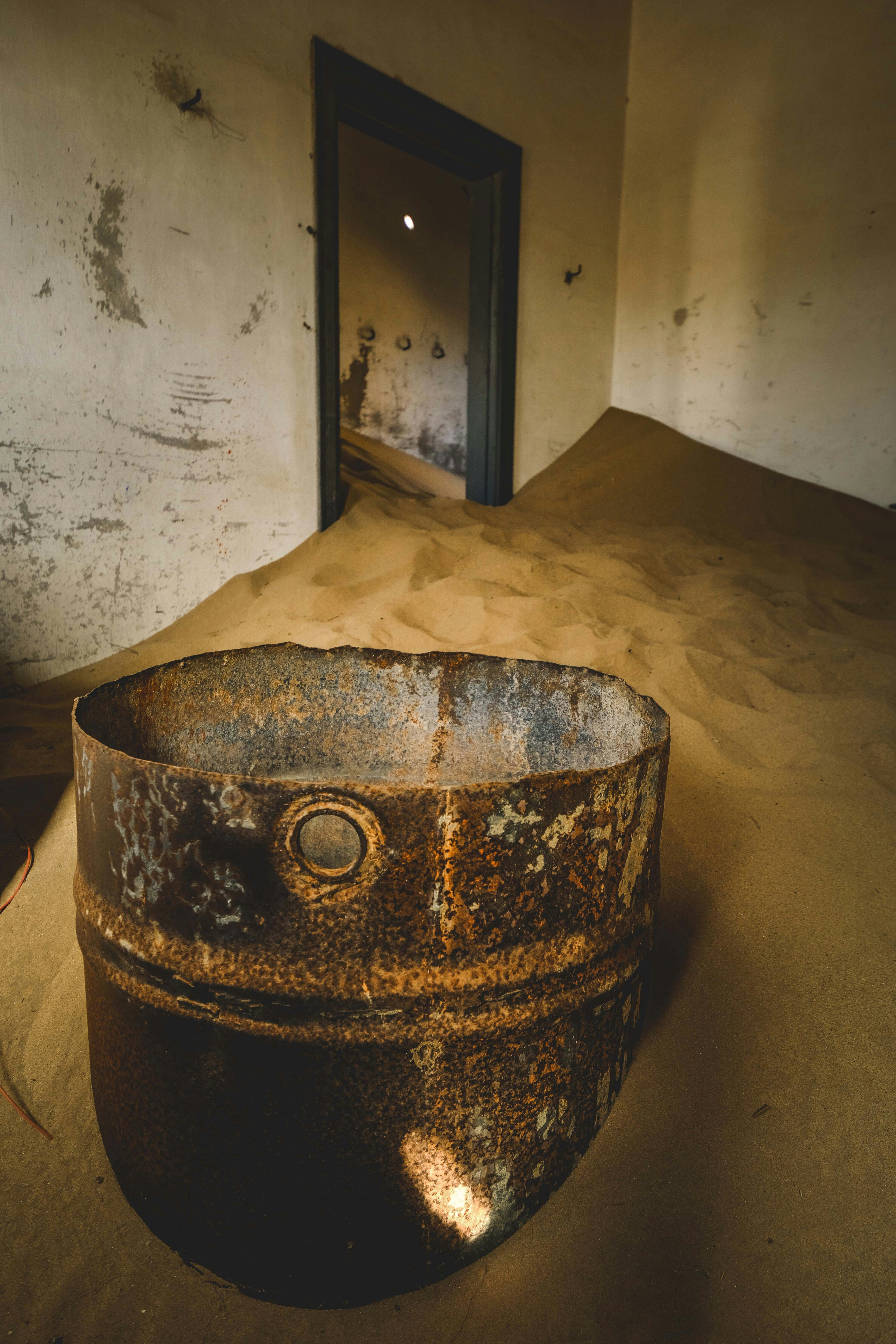 Sand floods an old building's interior.