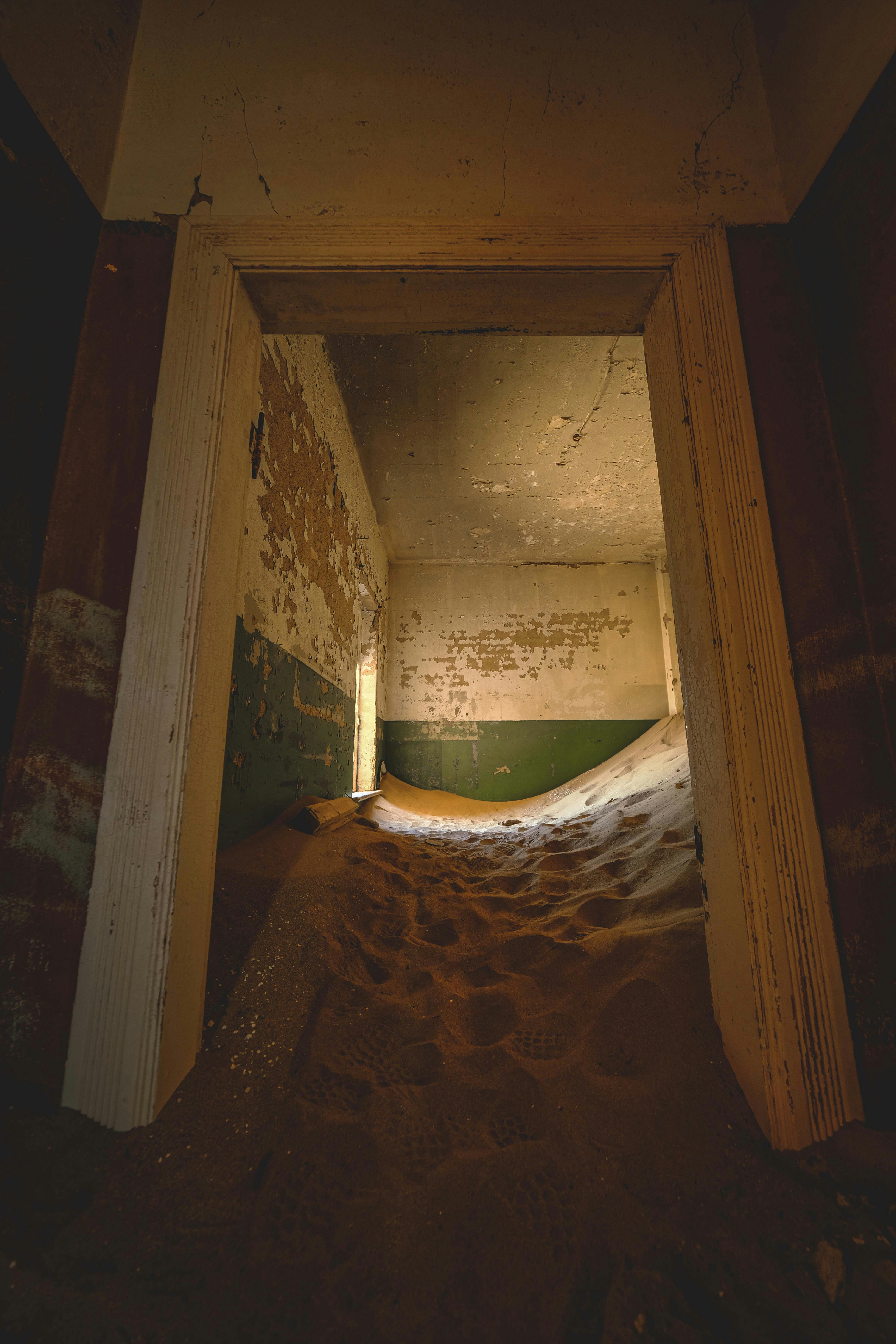 Sand dunes fill an abandoned room's interior.