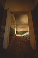 Sand dunes fill an abandoned room's interior.