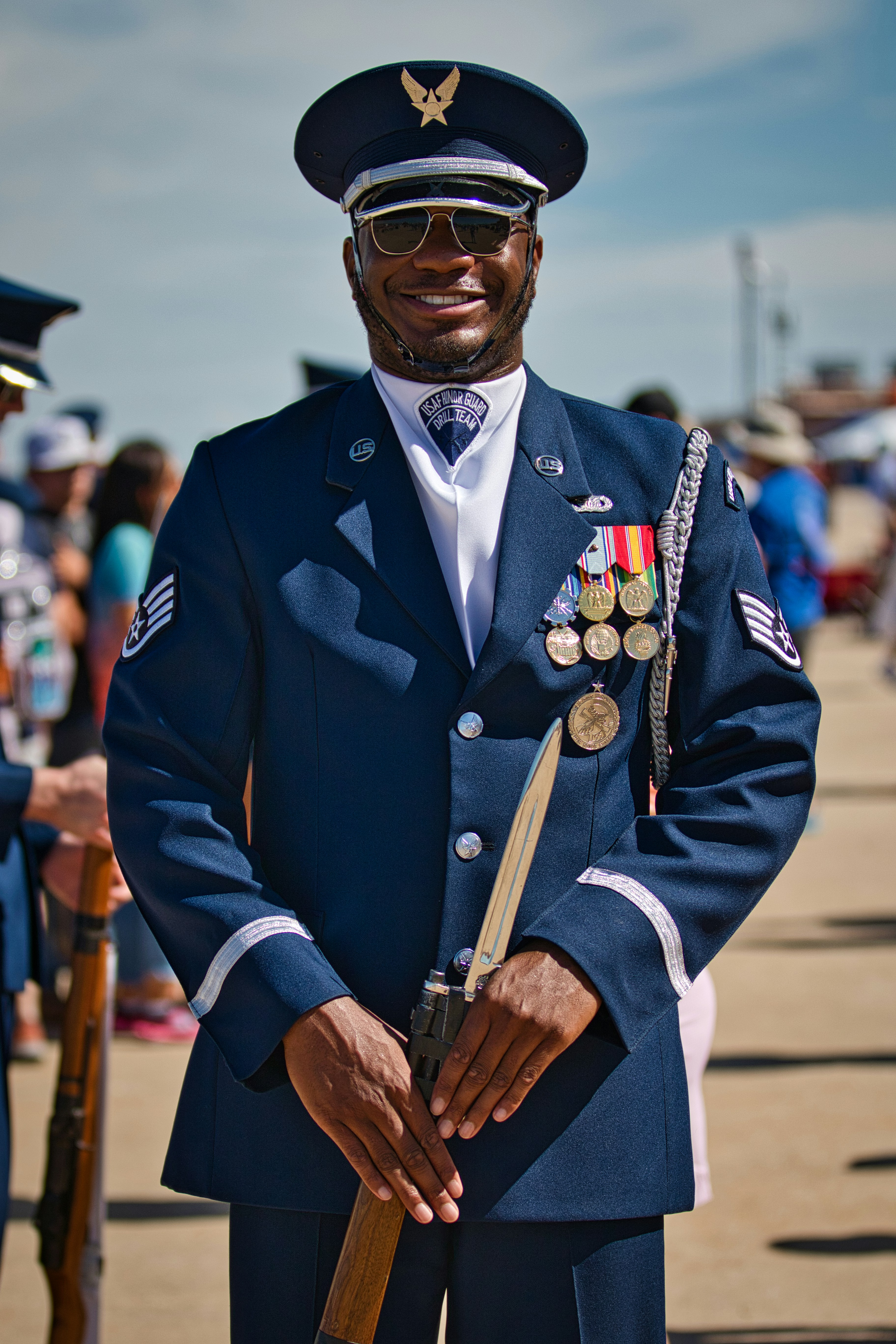 Airman in uniform proudly poses with a rifle. photo  Free Blue Image on  Unsplash