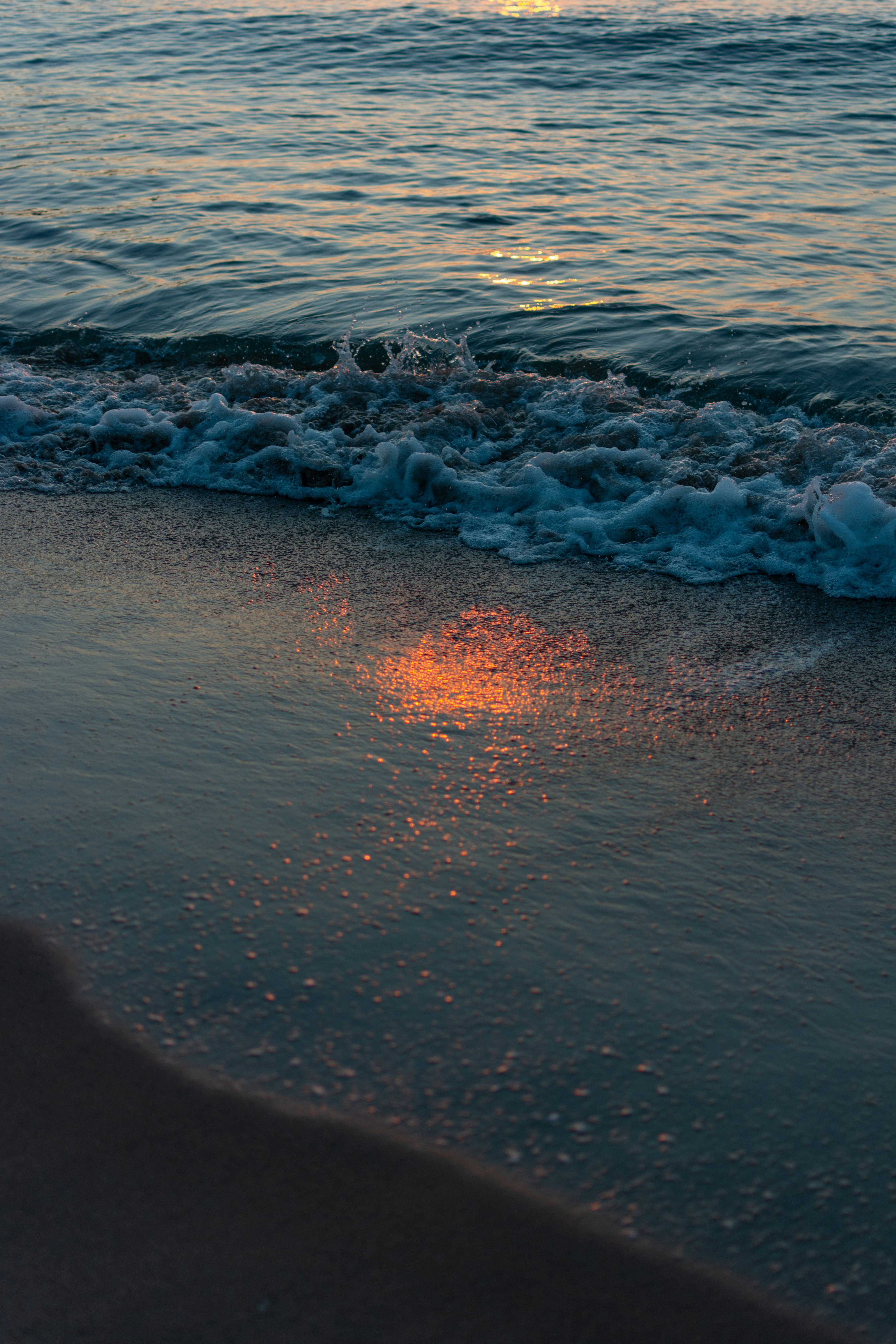 Sunrise reflection on the ocean's surface.